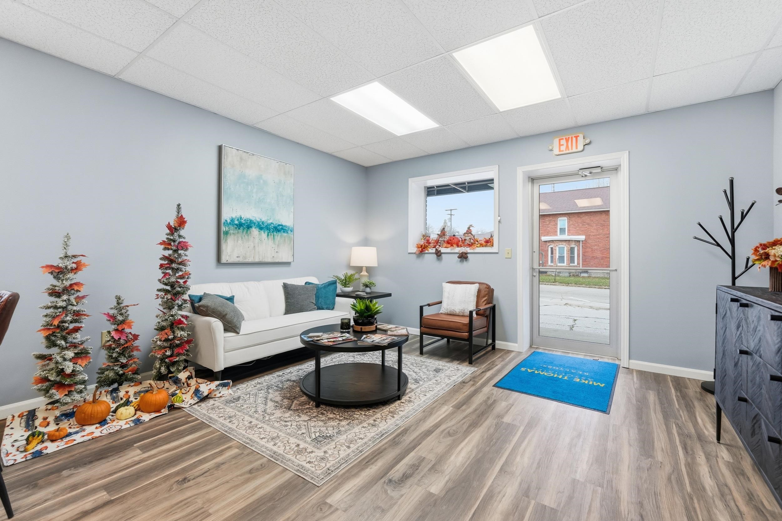 Living room featuring a paneled ceiling and wood finished floors