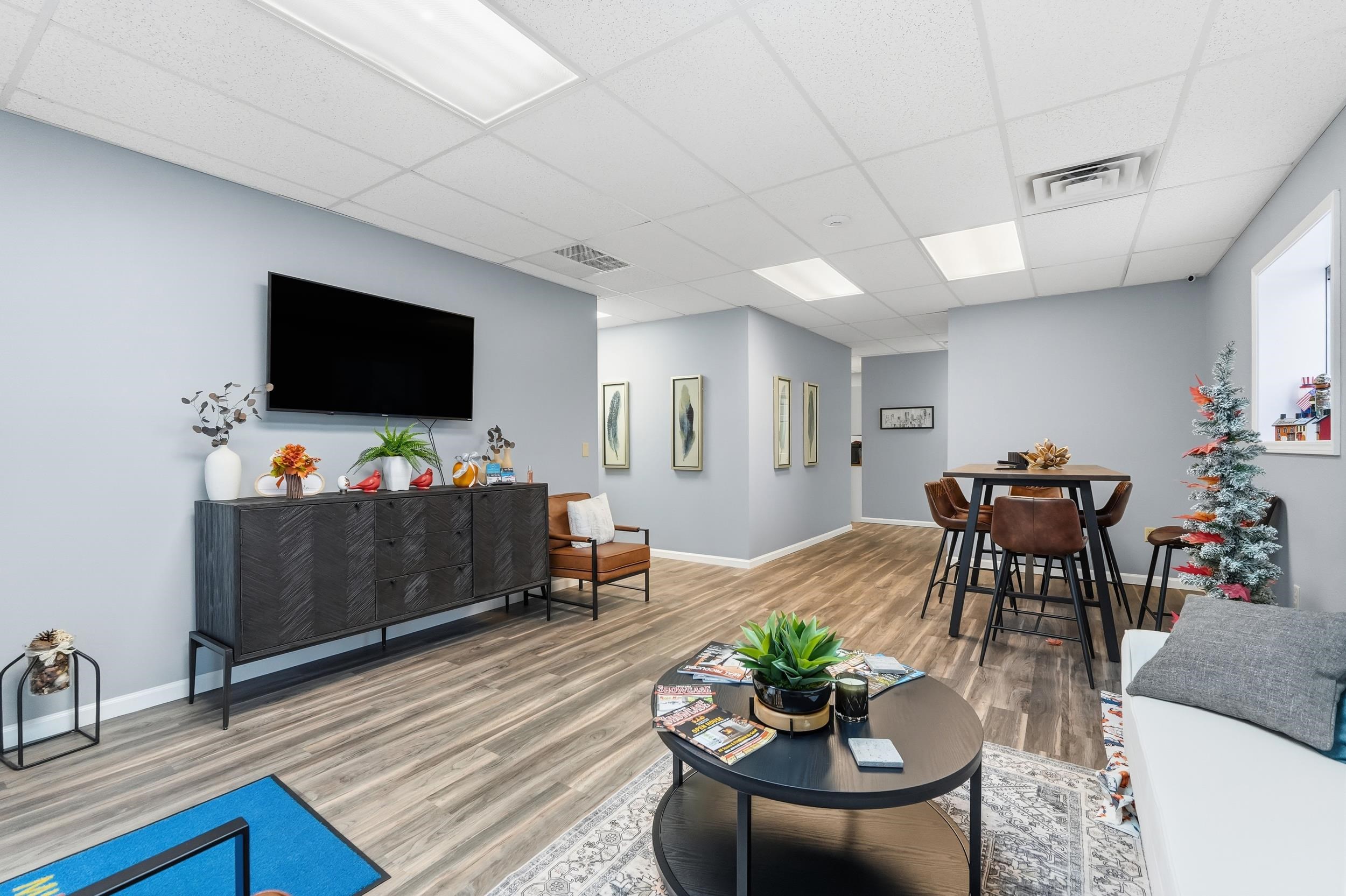 Living room with wood finished floors and a drop ceiling