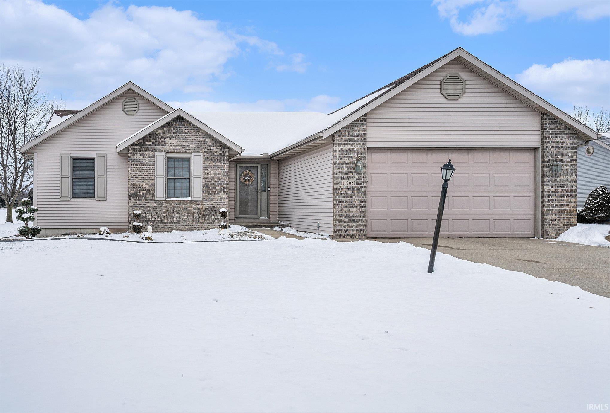 Ranch-style house with brick siding and an attached garage