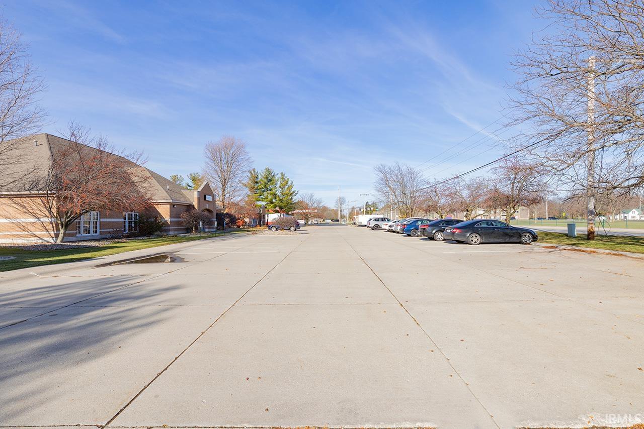 View of concrete road featuring curbs and a residential view