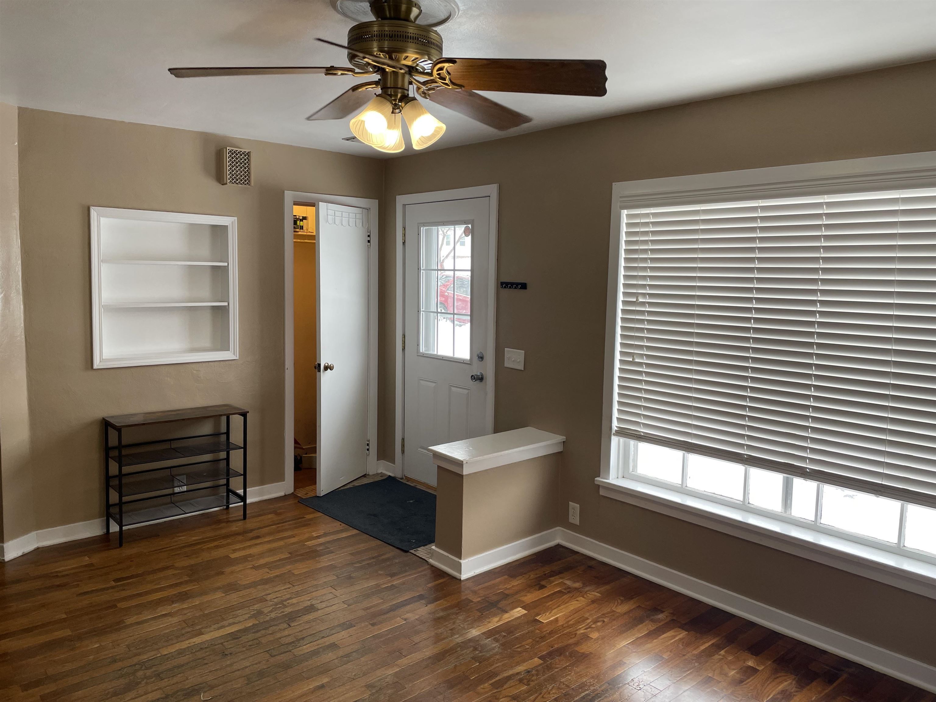 Foyer with a ceiling fan and dark wood finished floors