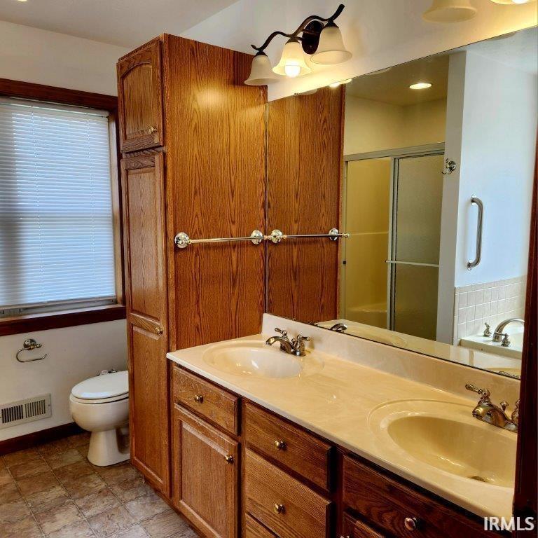 Full bathroom featuring double vanity, a stall shower, a garden tub, and recessed lighting
