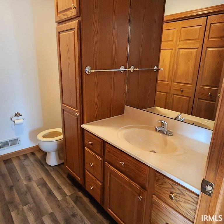Bathroom with dark wood finished floors and vanity