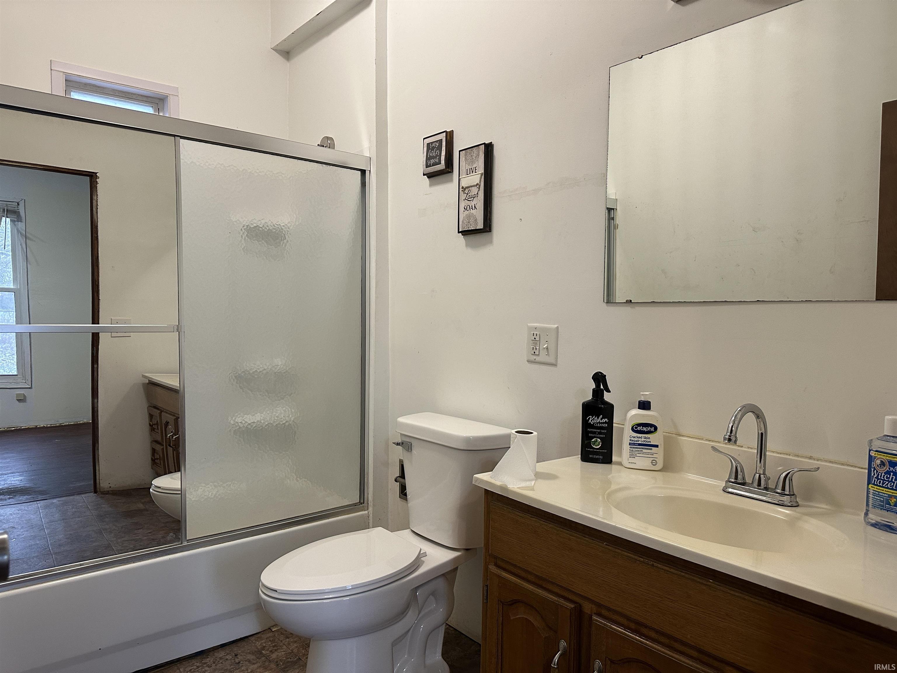 Full bath with vanity and enclosed tub / shower combo