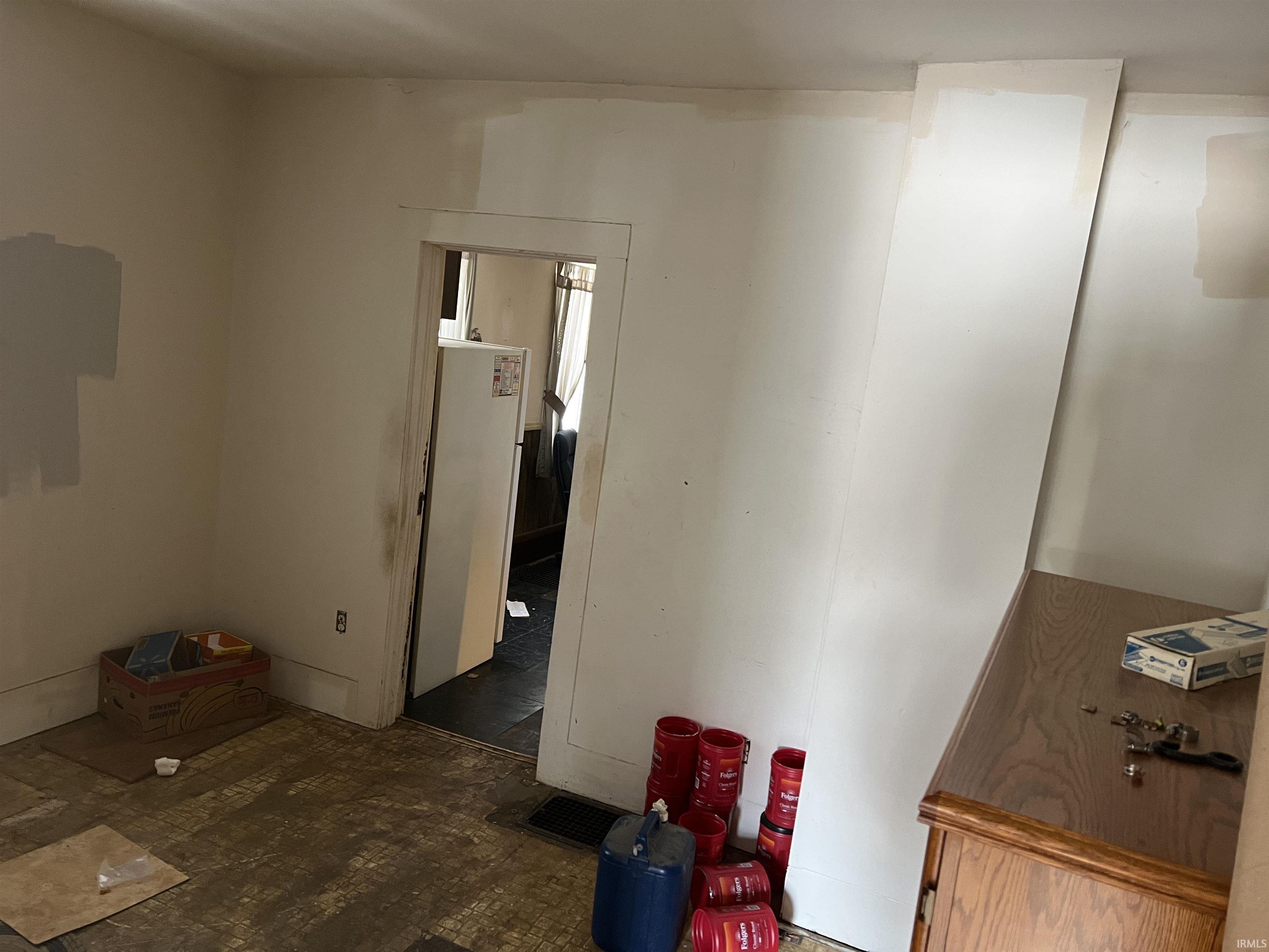 Bedroom featuring freestanding refrigerator