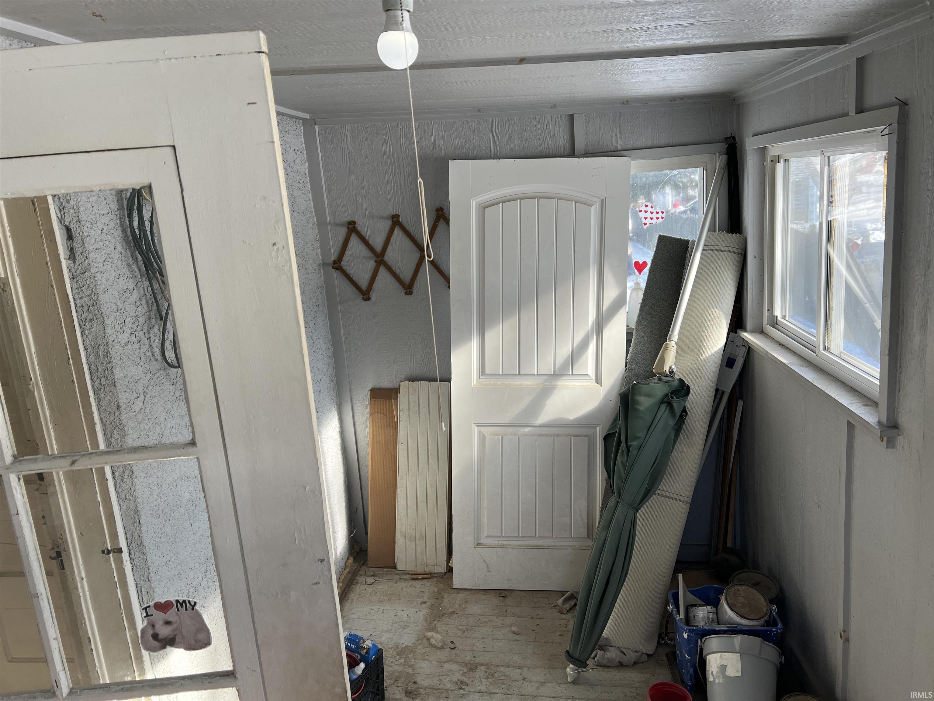 Laundry area featuring light wood finished floors