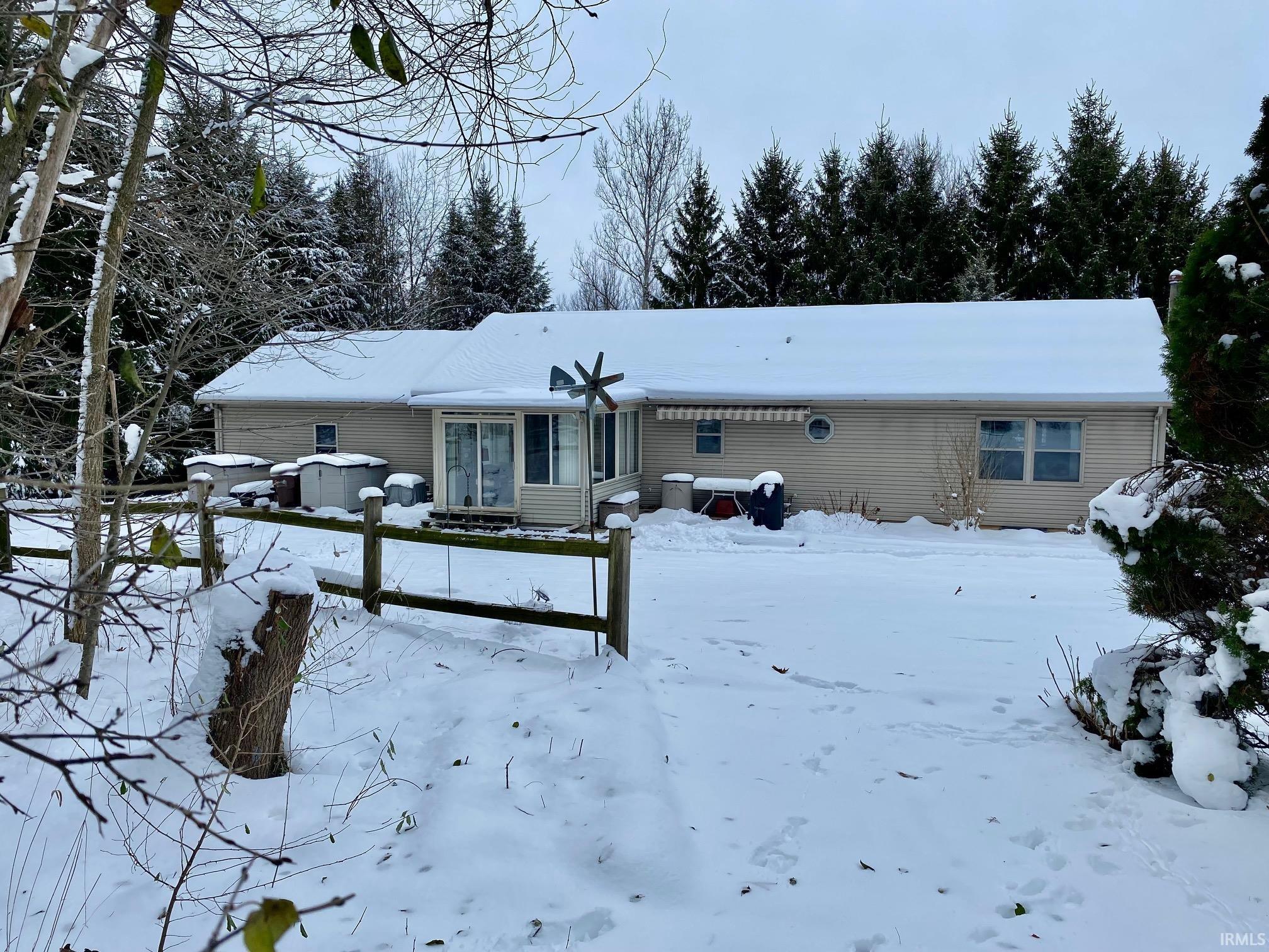 Snow covered house with entry steps
