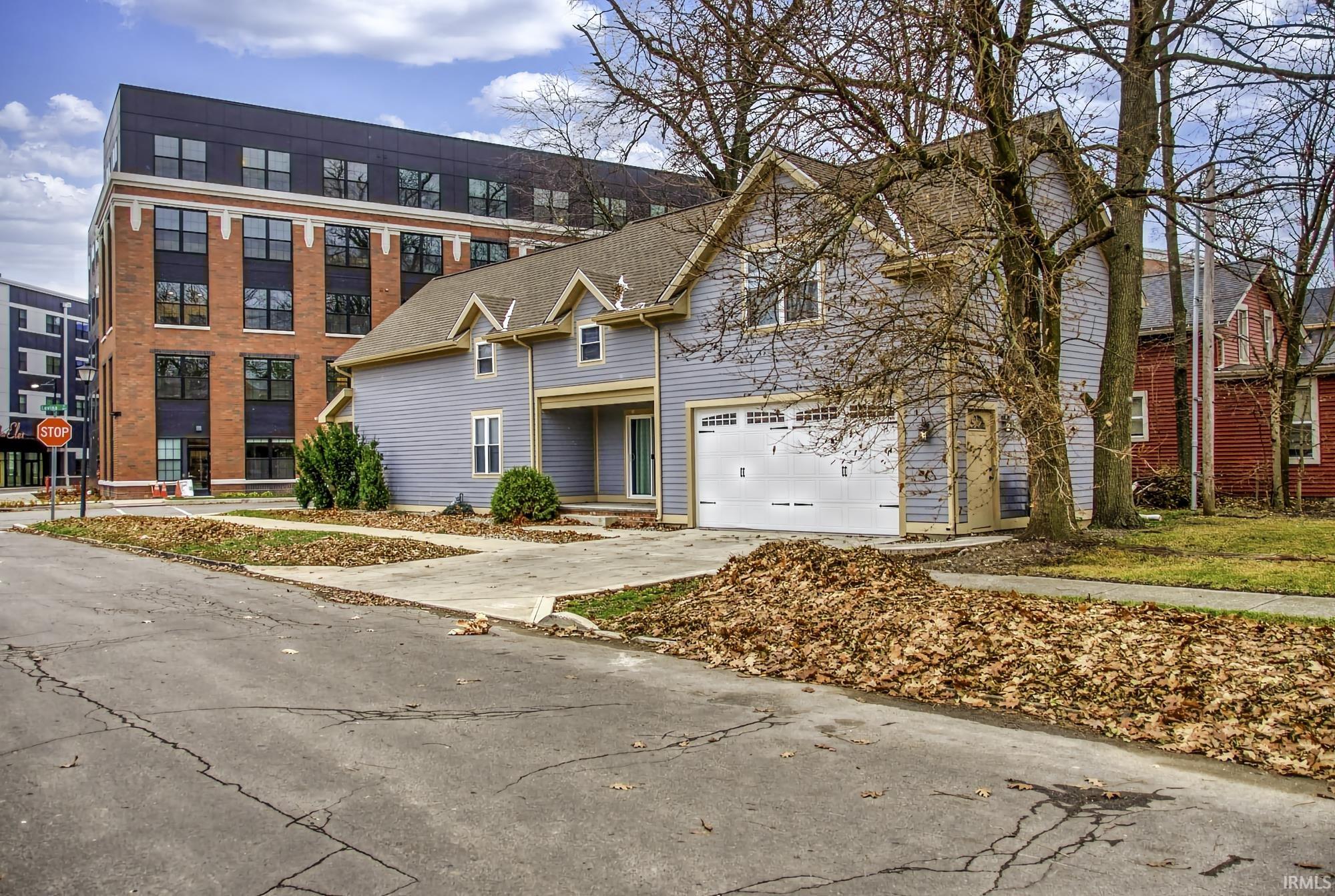 Traditional-style home featuring concrete driveway and an attached garage