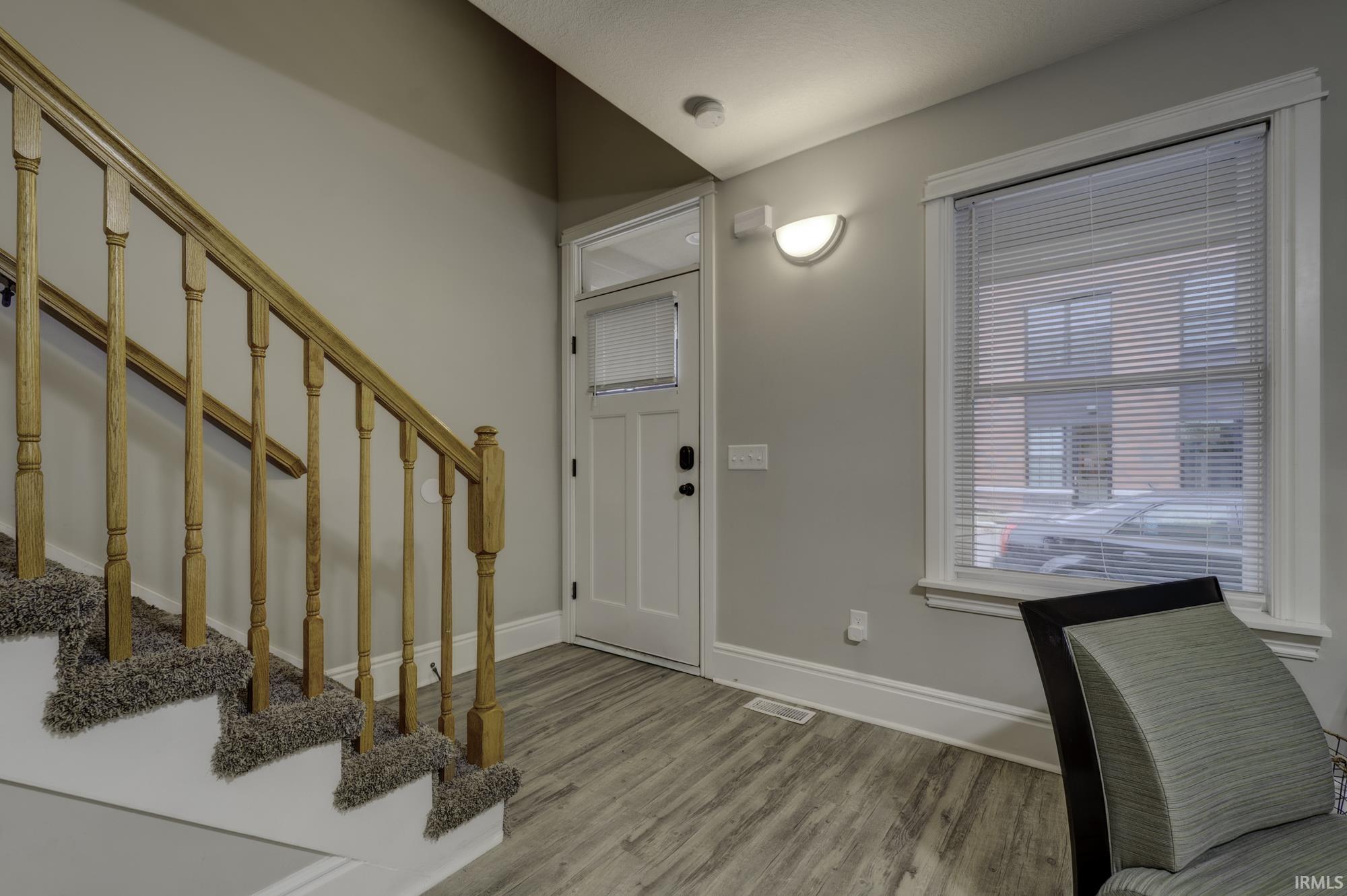 Entryway featuring stairway and wood finished floors