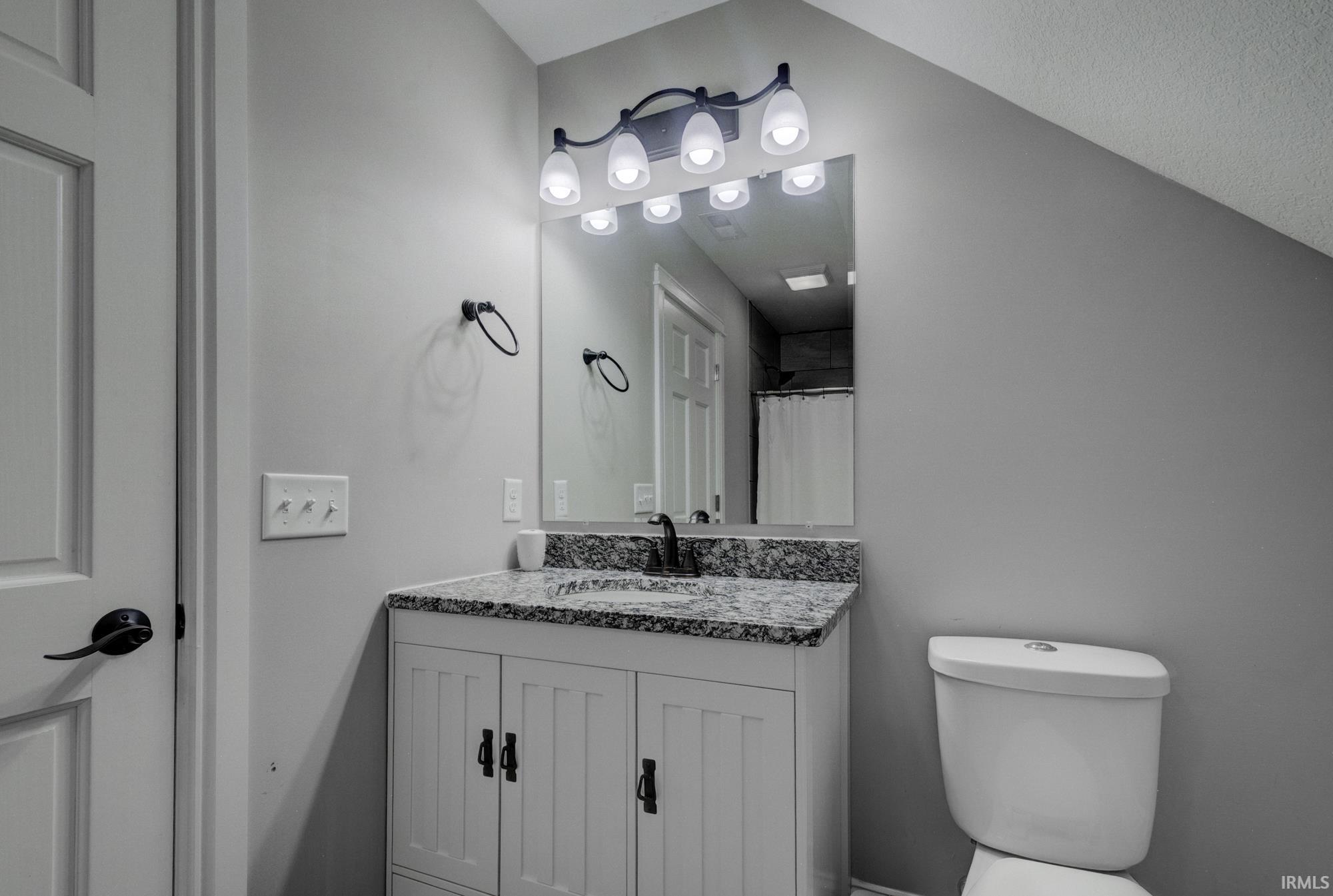 Full bathroom with vanity and a shower with curtain