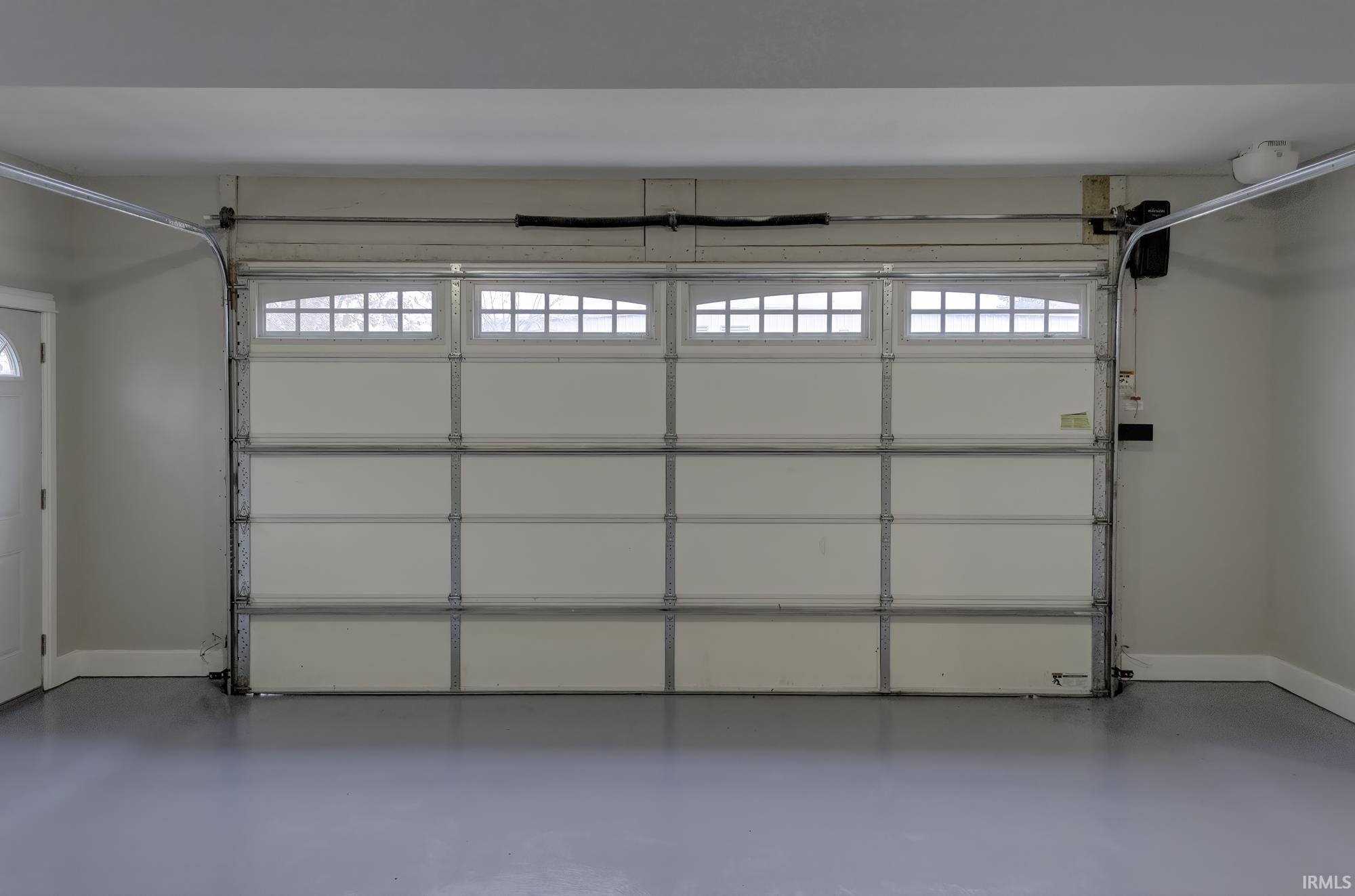 Garage featuring baseboards