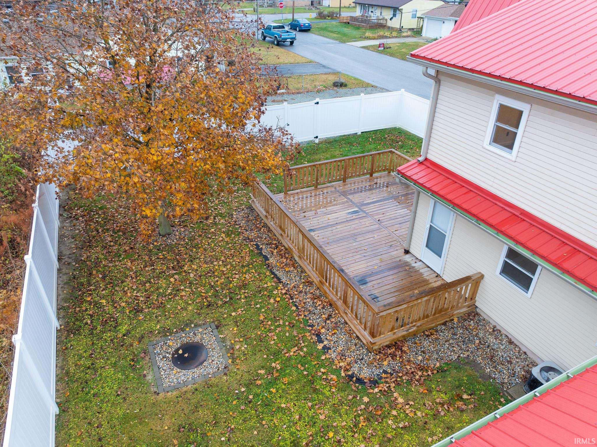 Fenced yard featuring a wooden deck and a residential view