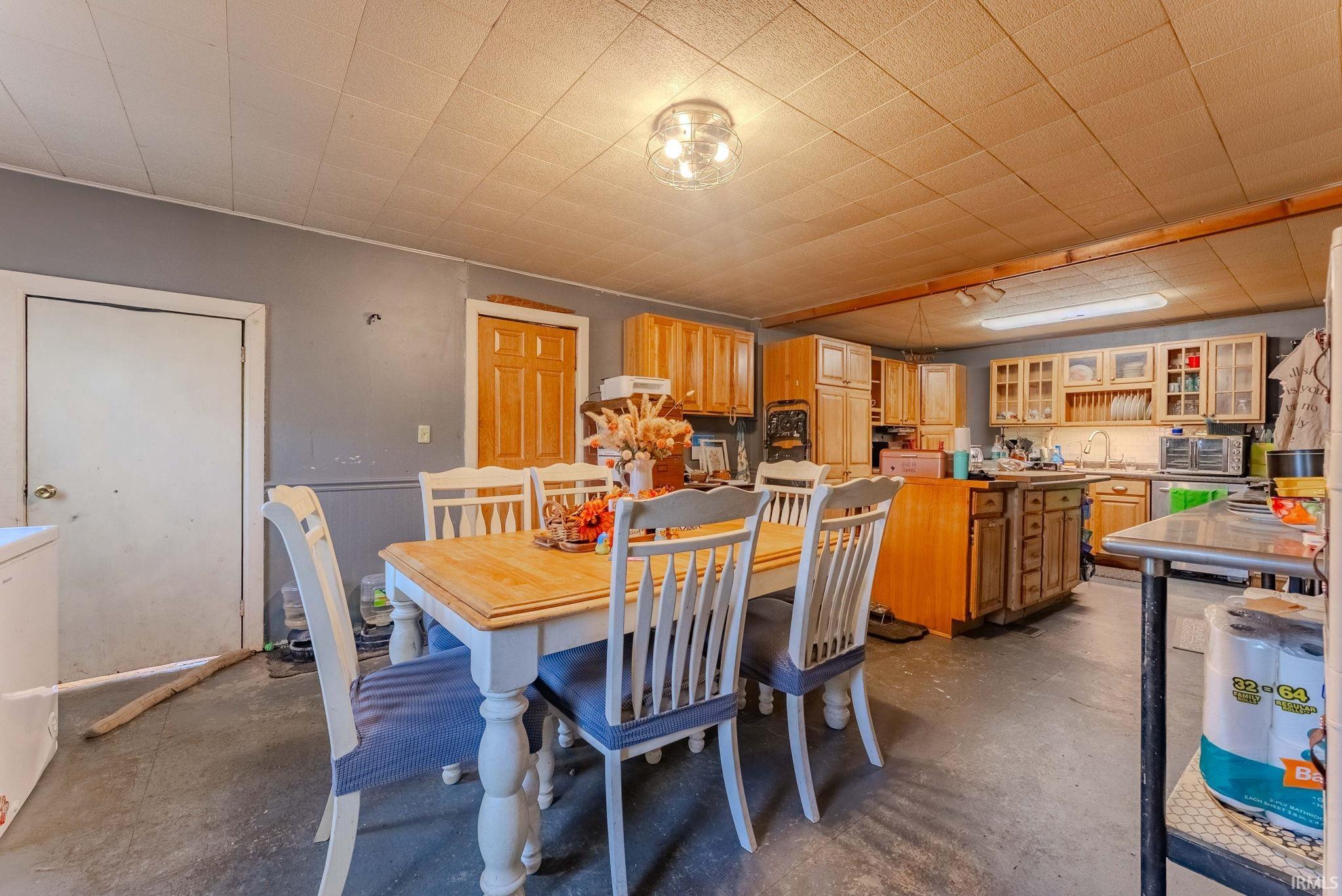Dining room featuring concrete flooring and washer / dryer