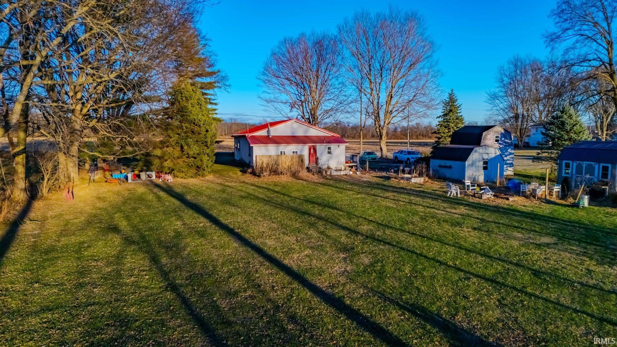 View of green lawn with a storage unit