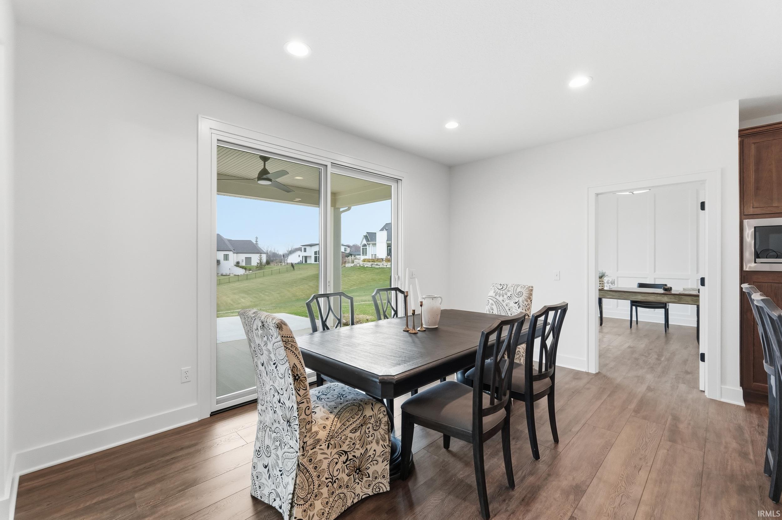 Dining space featuring recessed lighting and dark wood-type flooring