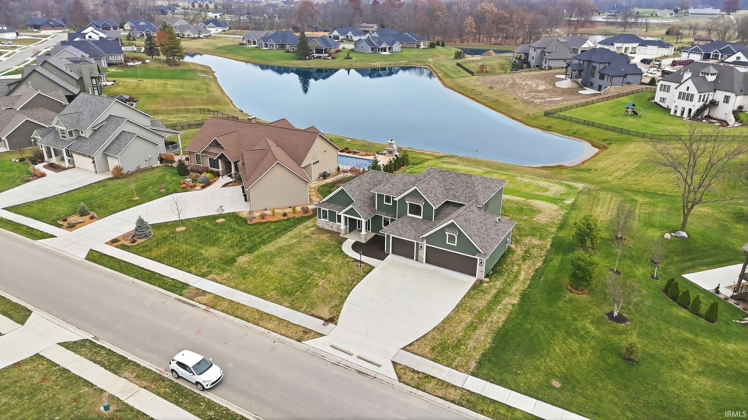 Aerial view of residential area featuring a large body of water