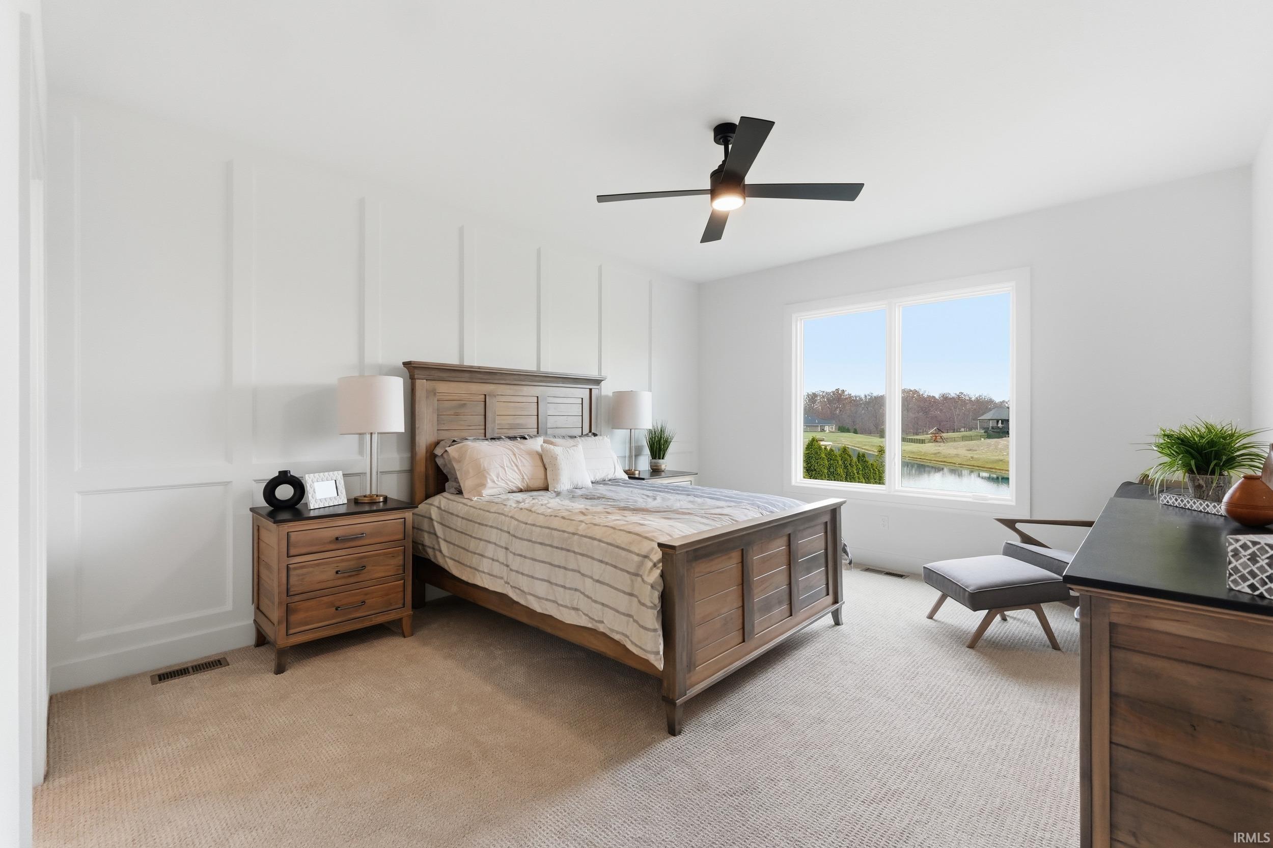 Bedroom with light carpet and ceiling fan