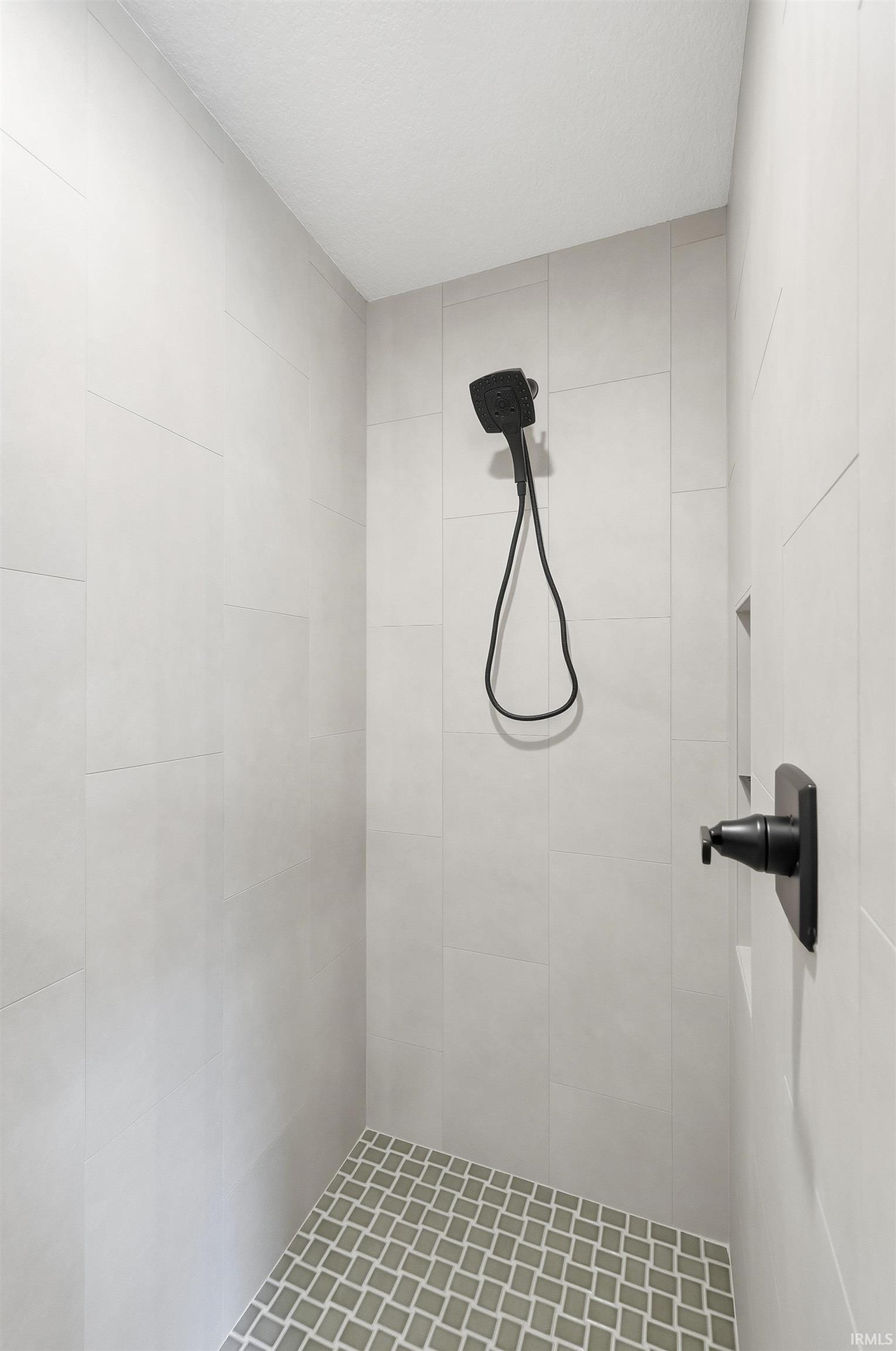 Full bathroom featuring tiled shower