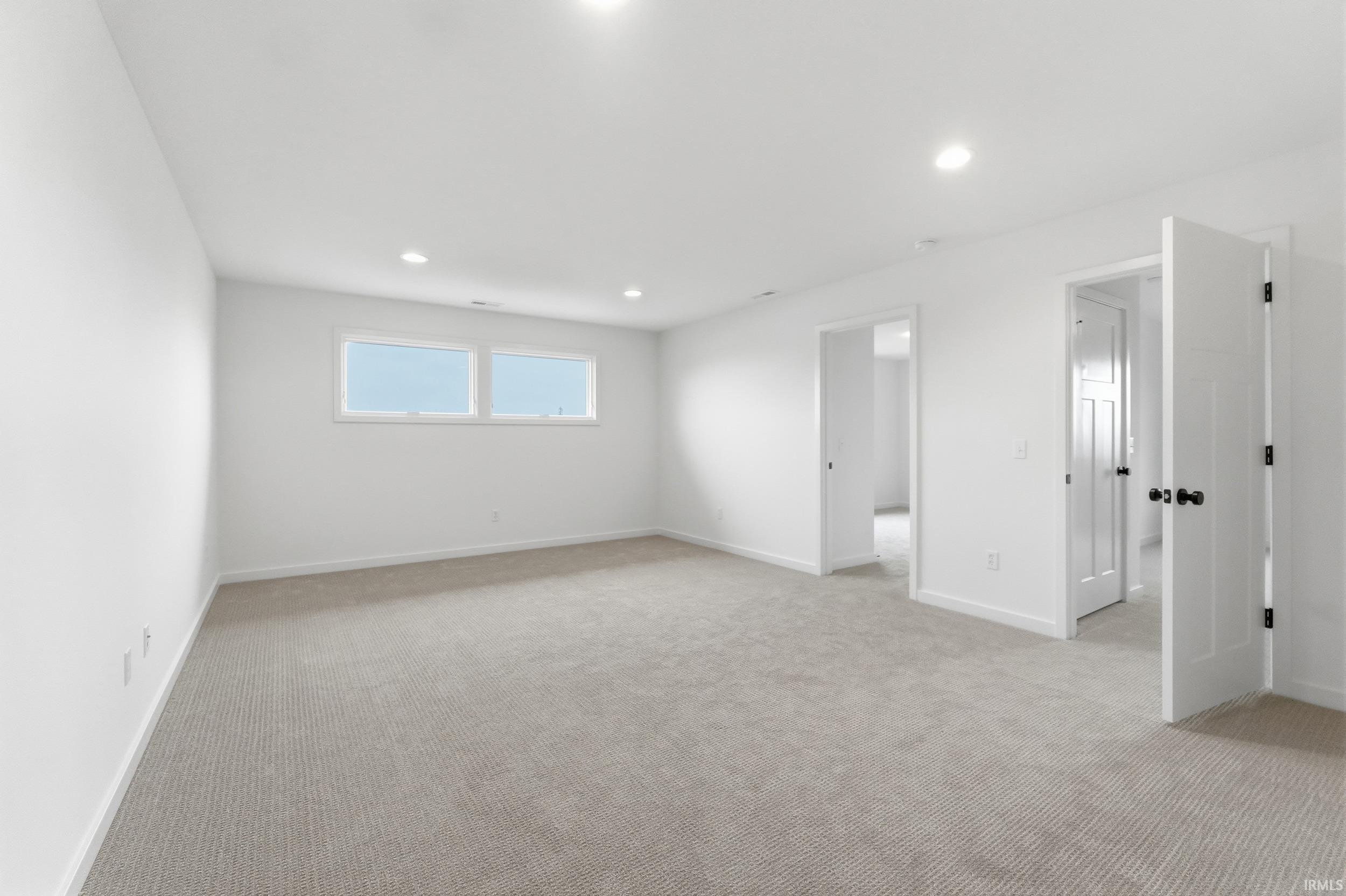 Unfurnished bedroom featuring light carpet and recessed lighting