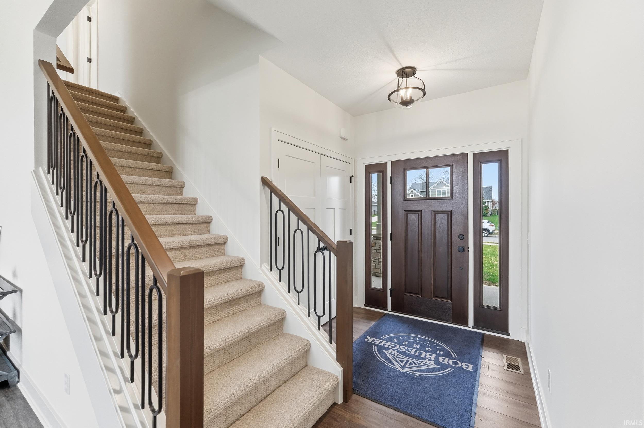 Entrance foyer featuring wood finished floors and stairway