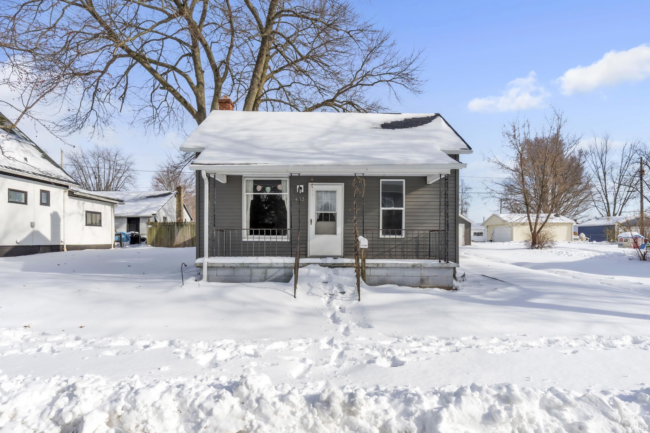 View of front of property featuring a porch and a chimney