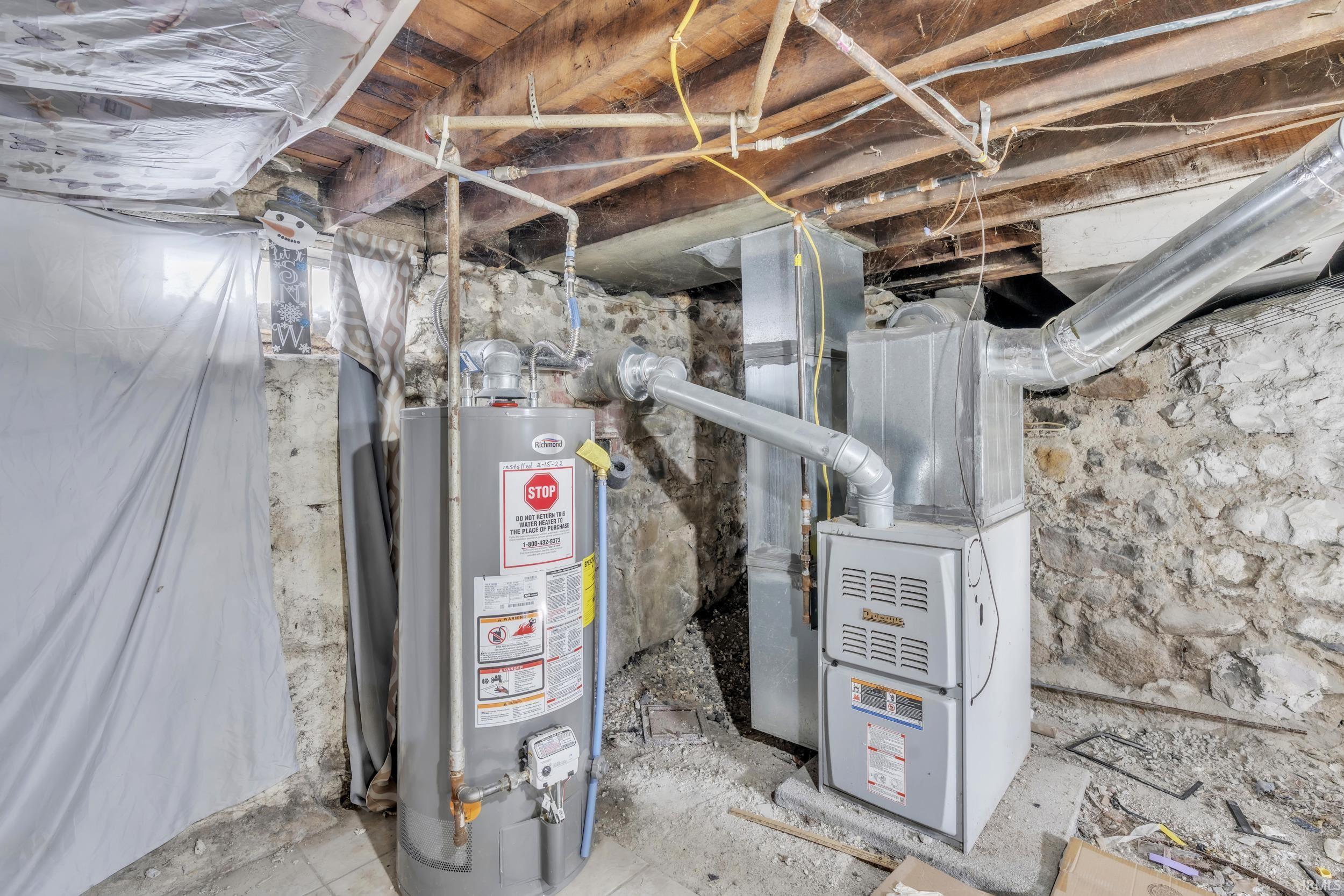 Utility room with gas water heater and heating unit