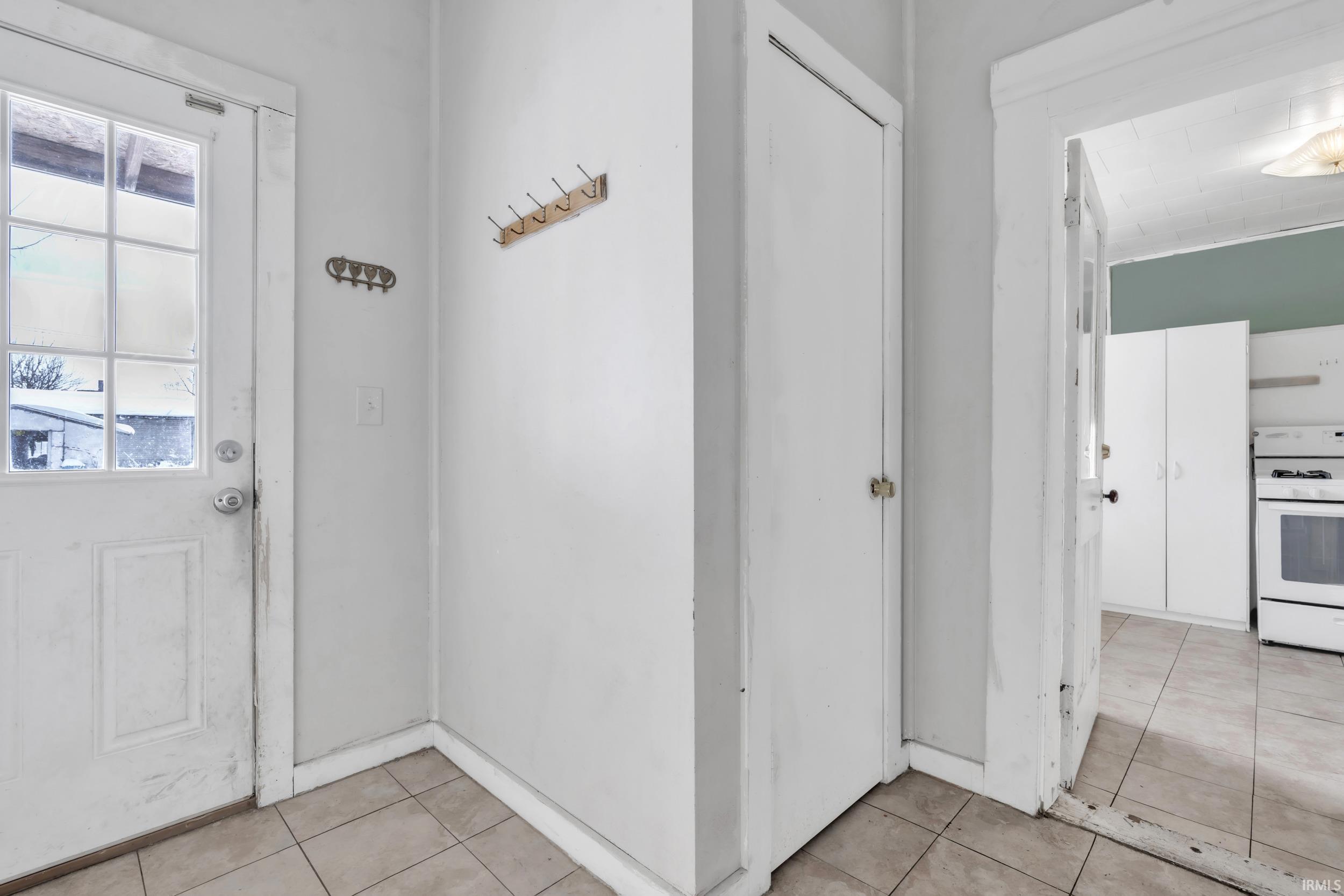 Doorway featuring tile patterned floors
