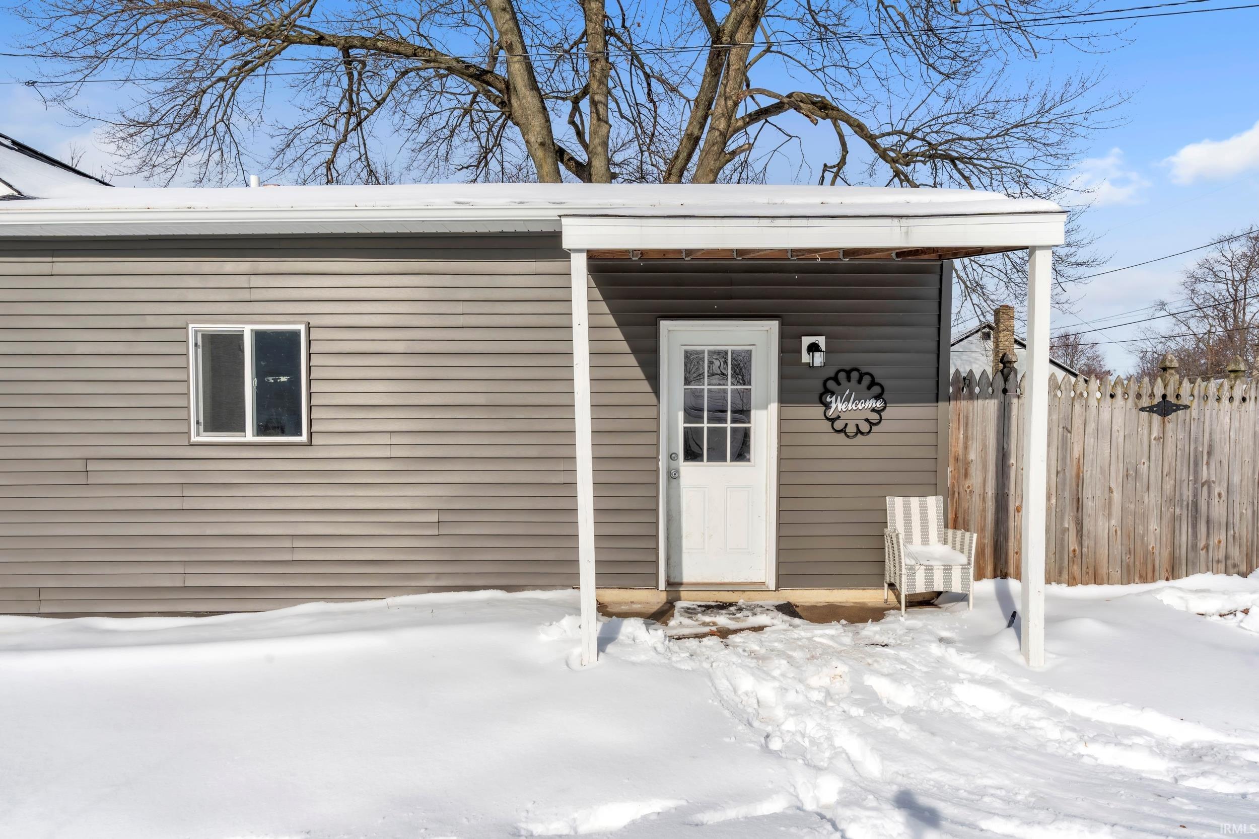 View of snow covered property entrance