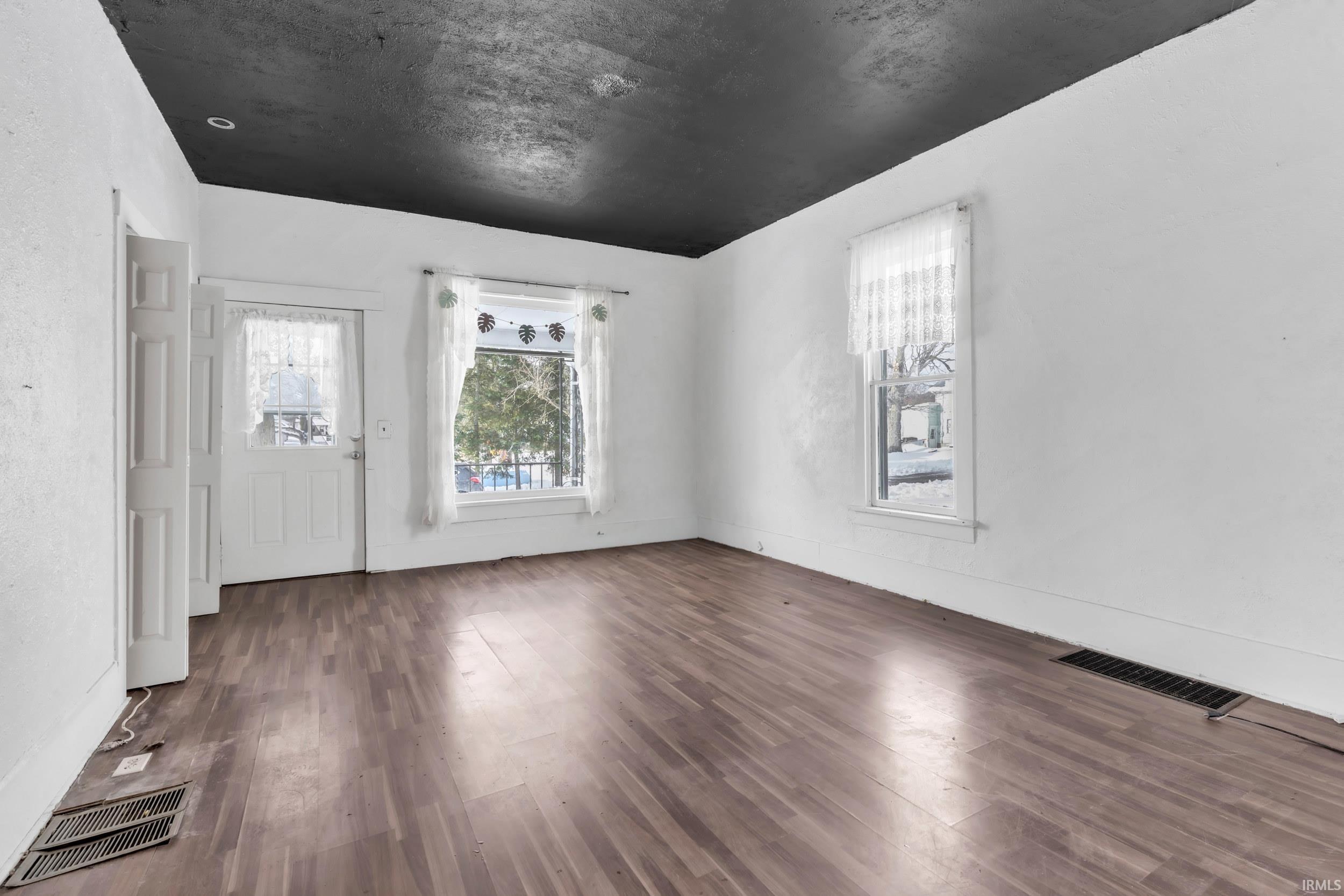 Foyer with dark wood-type flooring and healthy amount of natural light