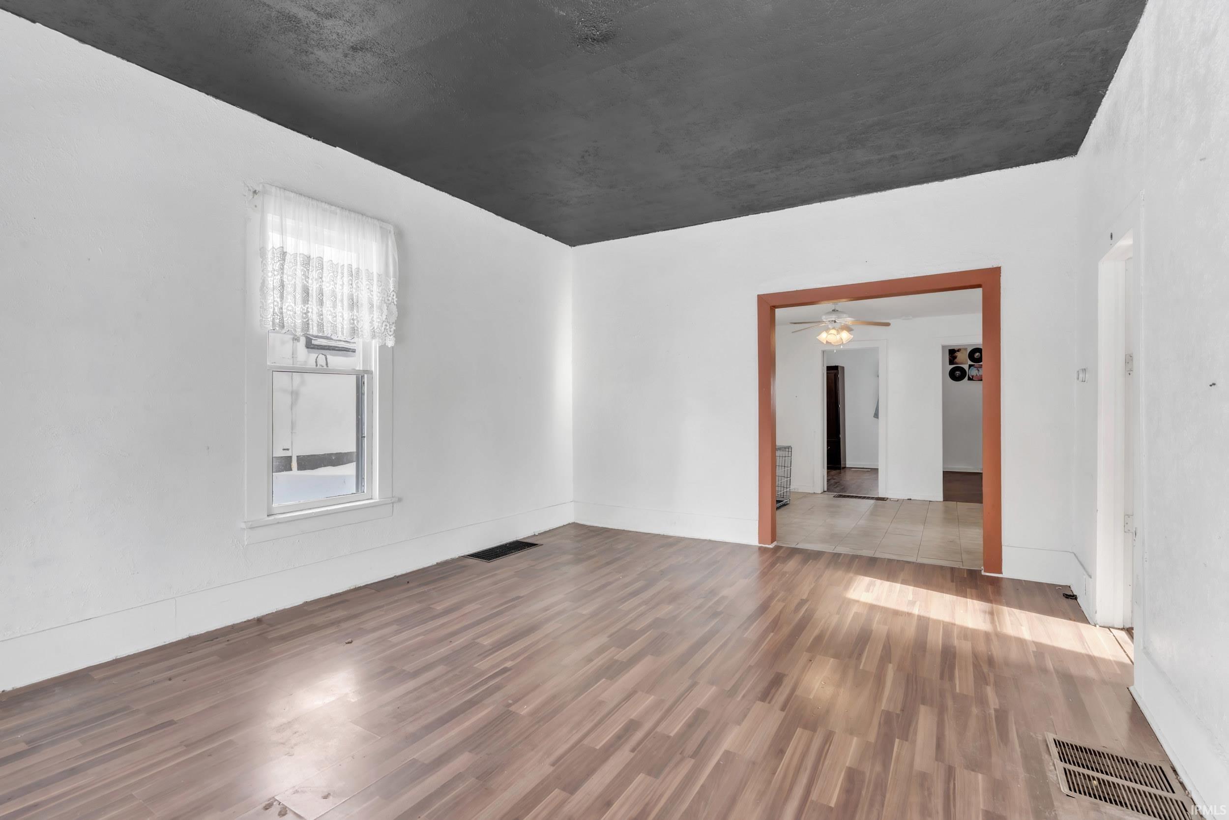 Spare room featuring wood finished floors and a ceiling fan