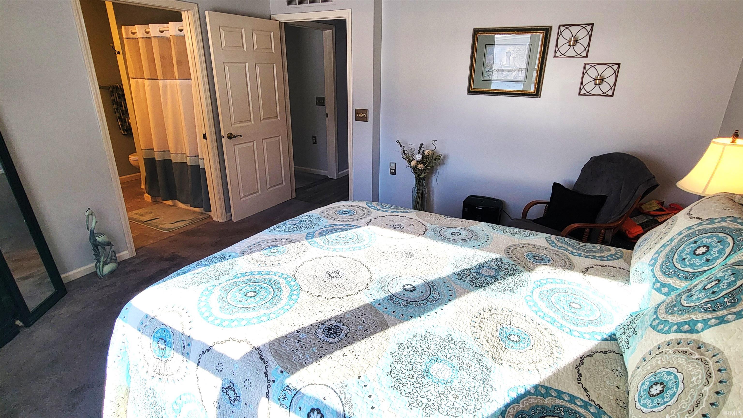 Bedroom featuring baseboards and ensuite bathroom