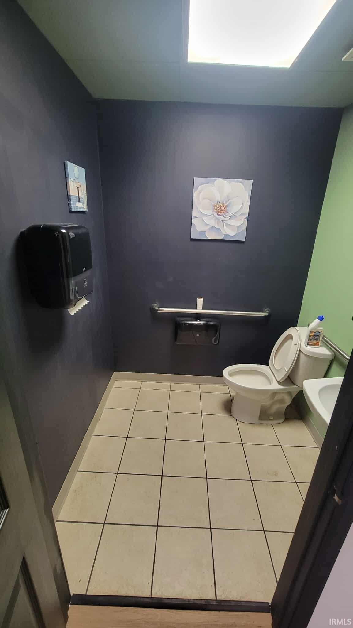Bathroom featuring light tile patterned floors and heating unit