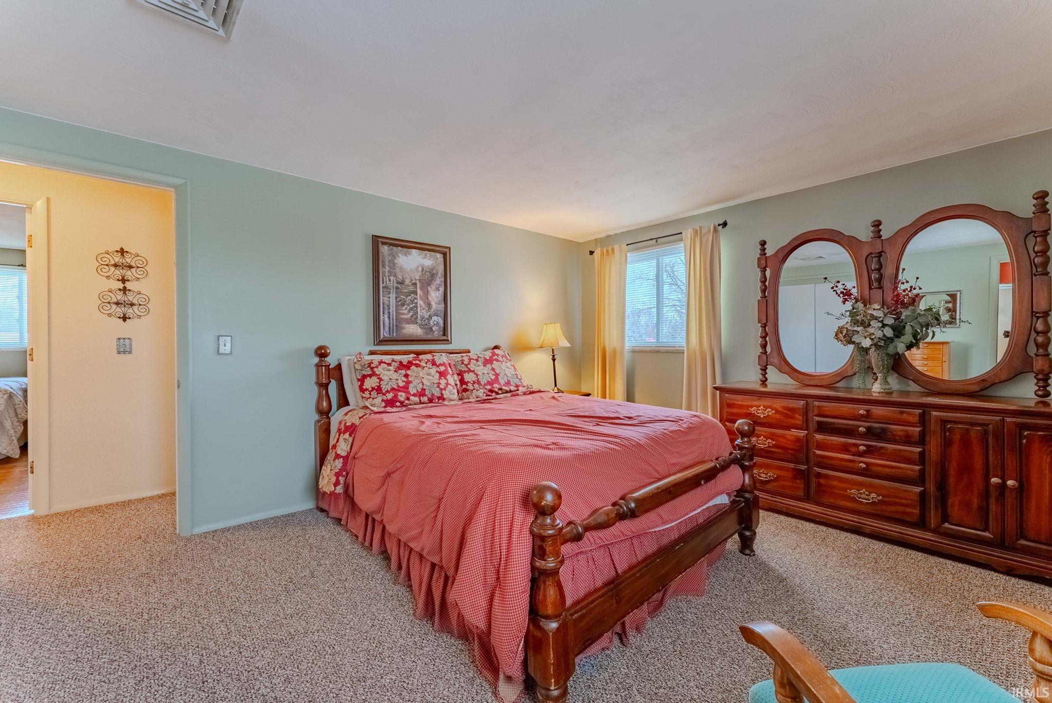 Bedroom with light carpet
