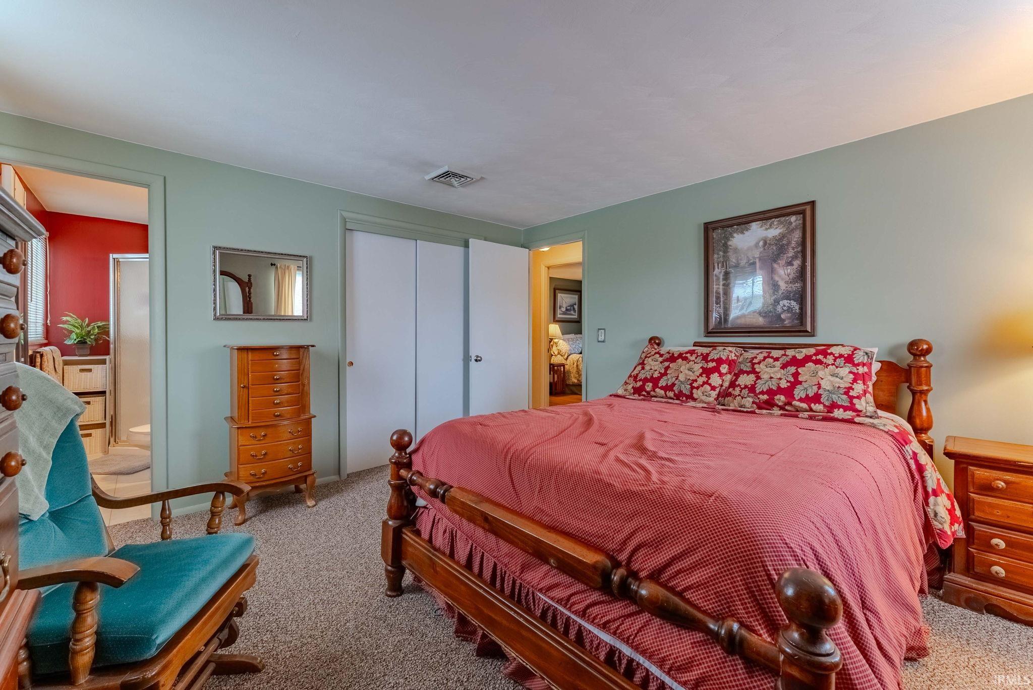Carpeted bedroom with a closet