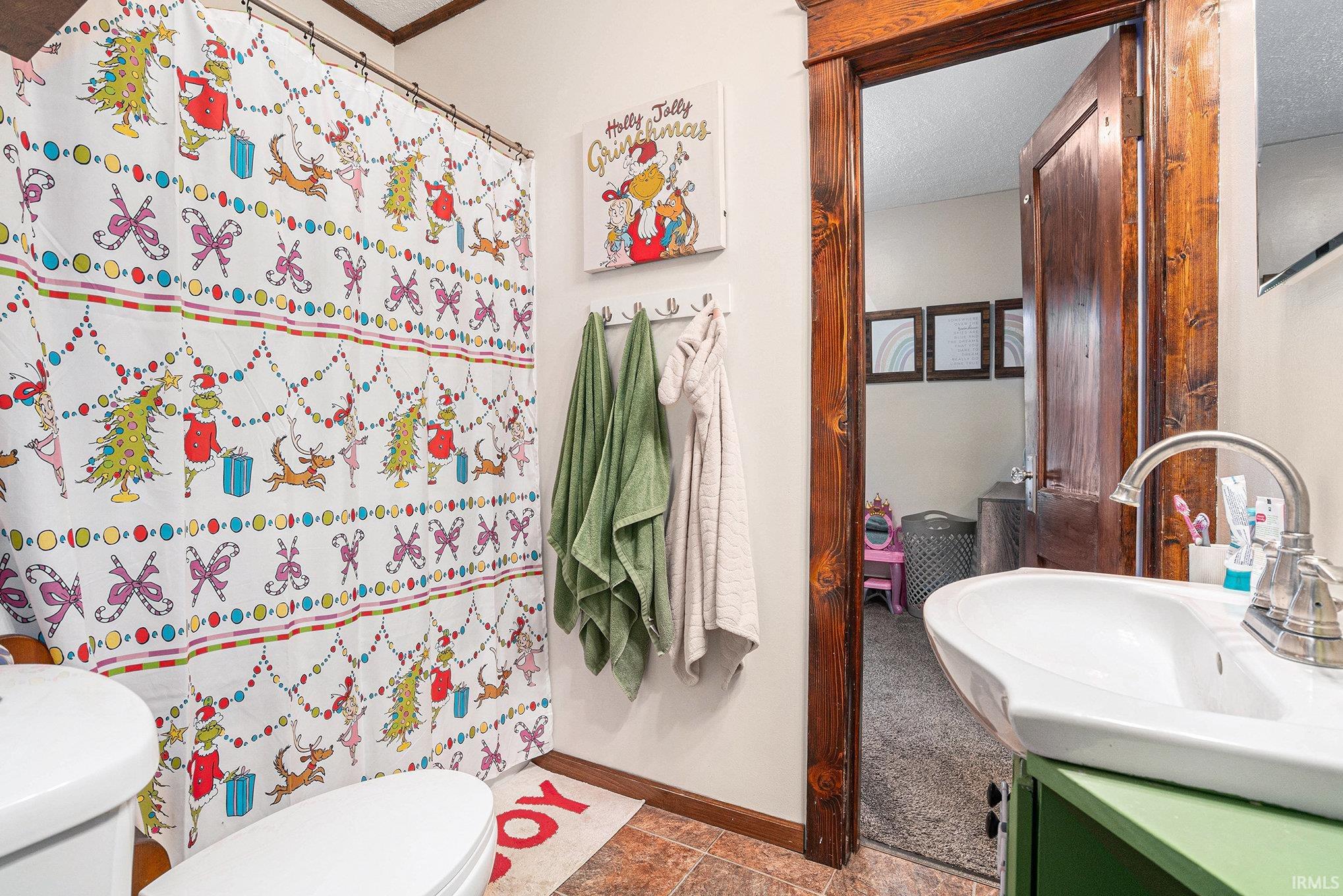 Bathroom featuring vanity, curtained shower, and a textured ceiling