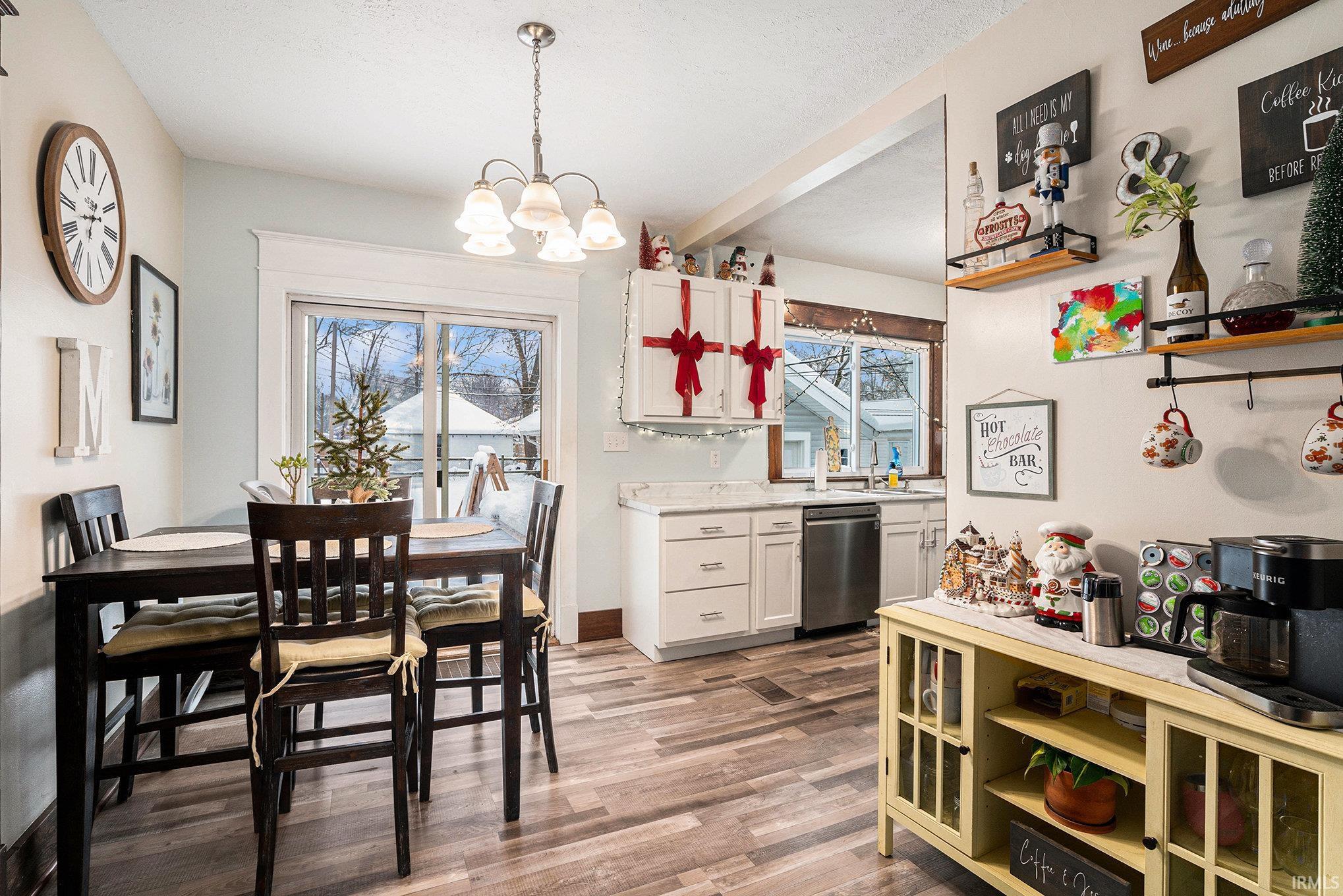 Dining area featuring light wood finished floors and a chandelier