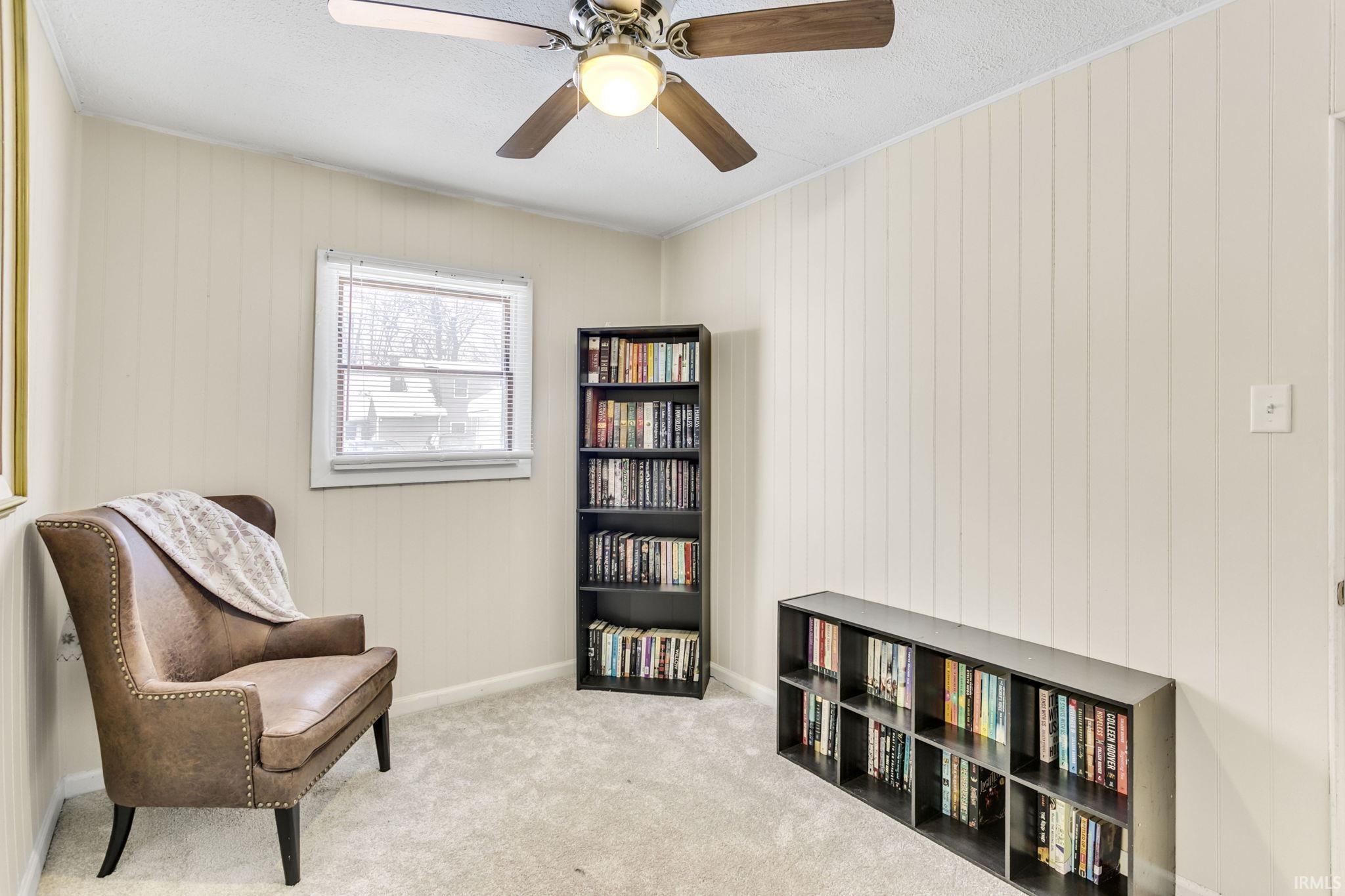 Sitting room with carpet floors and a ceiling fan
