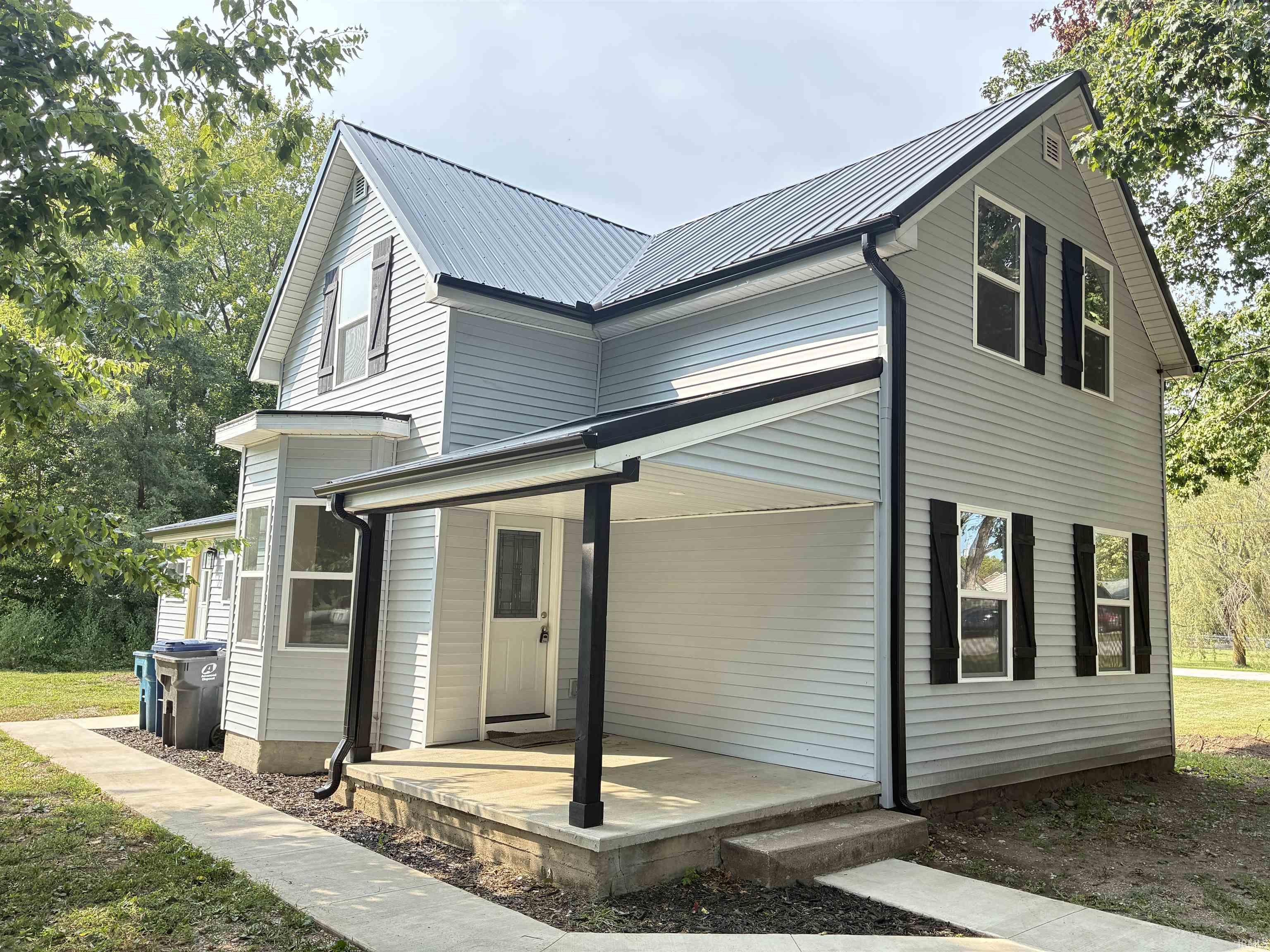 View of front of property with a metal roof and covered porch