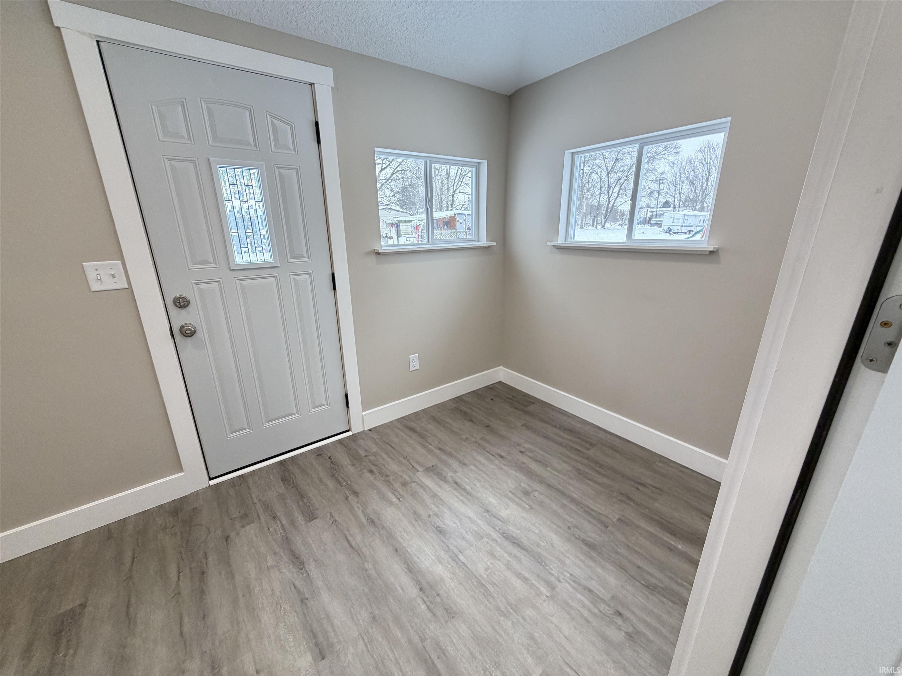 Entryway featuring a textured ceiling and light wood finished floors
