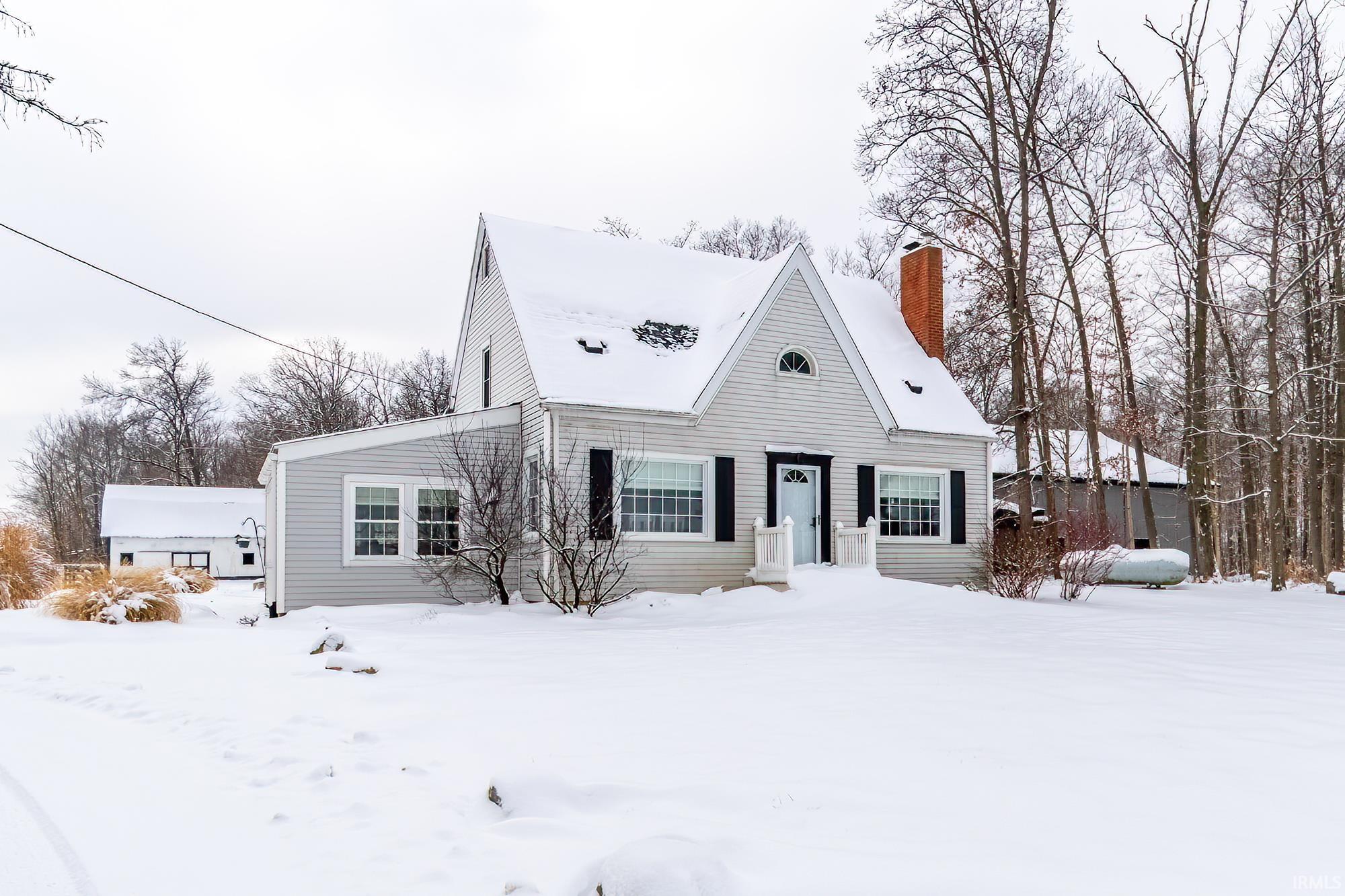 New england style home with a chimney