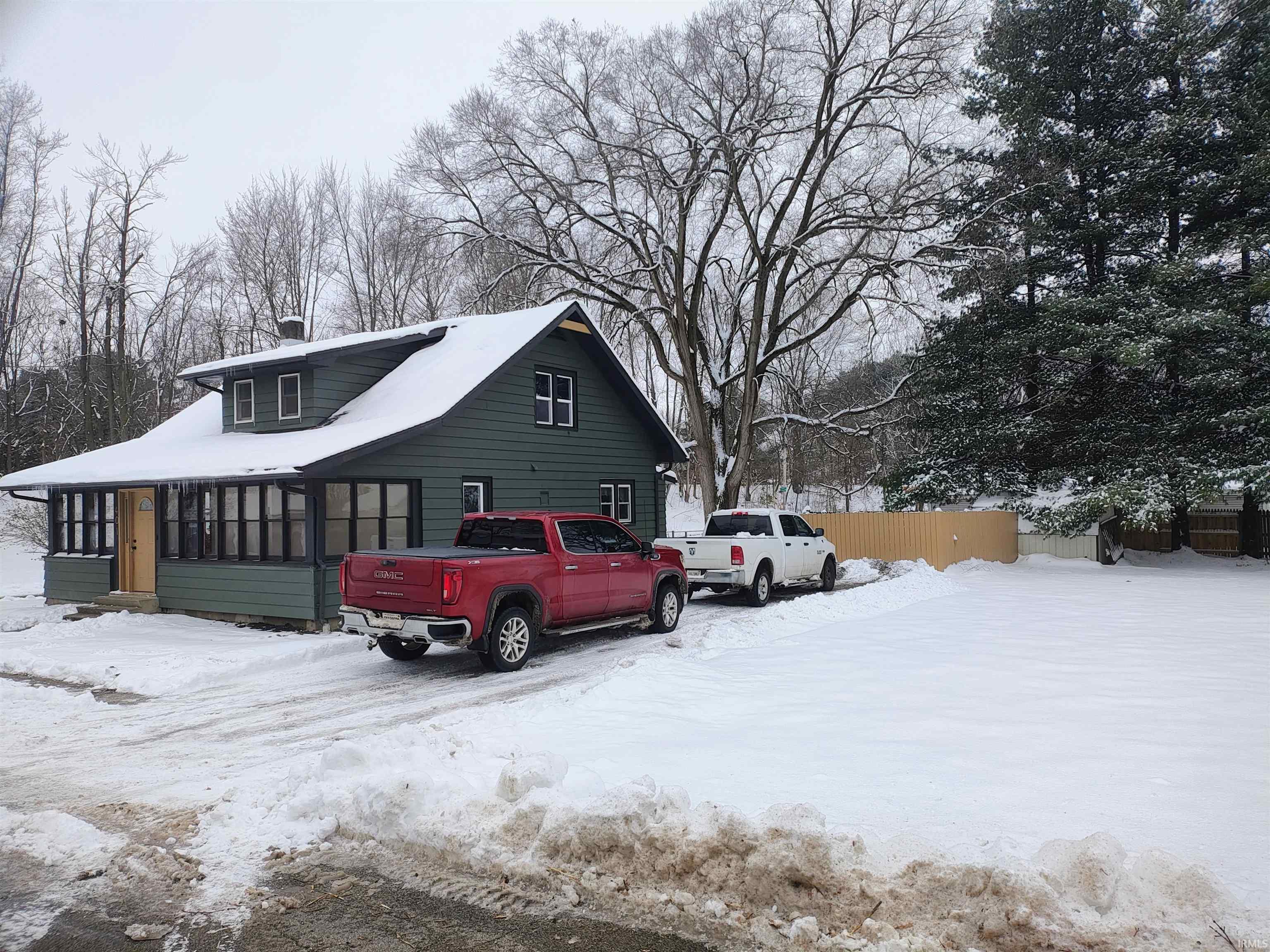 Snow covered property featuring a sunroom