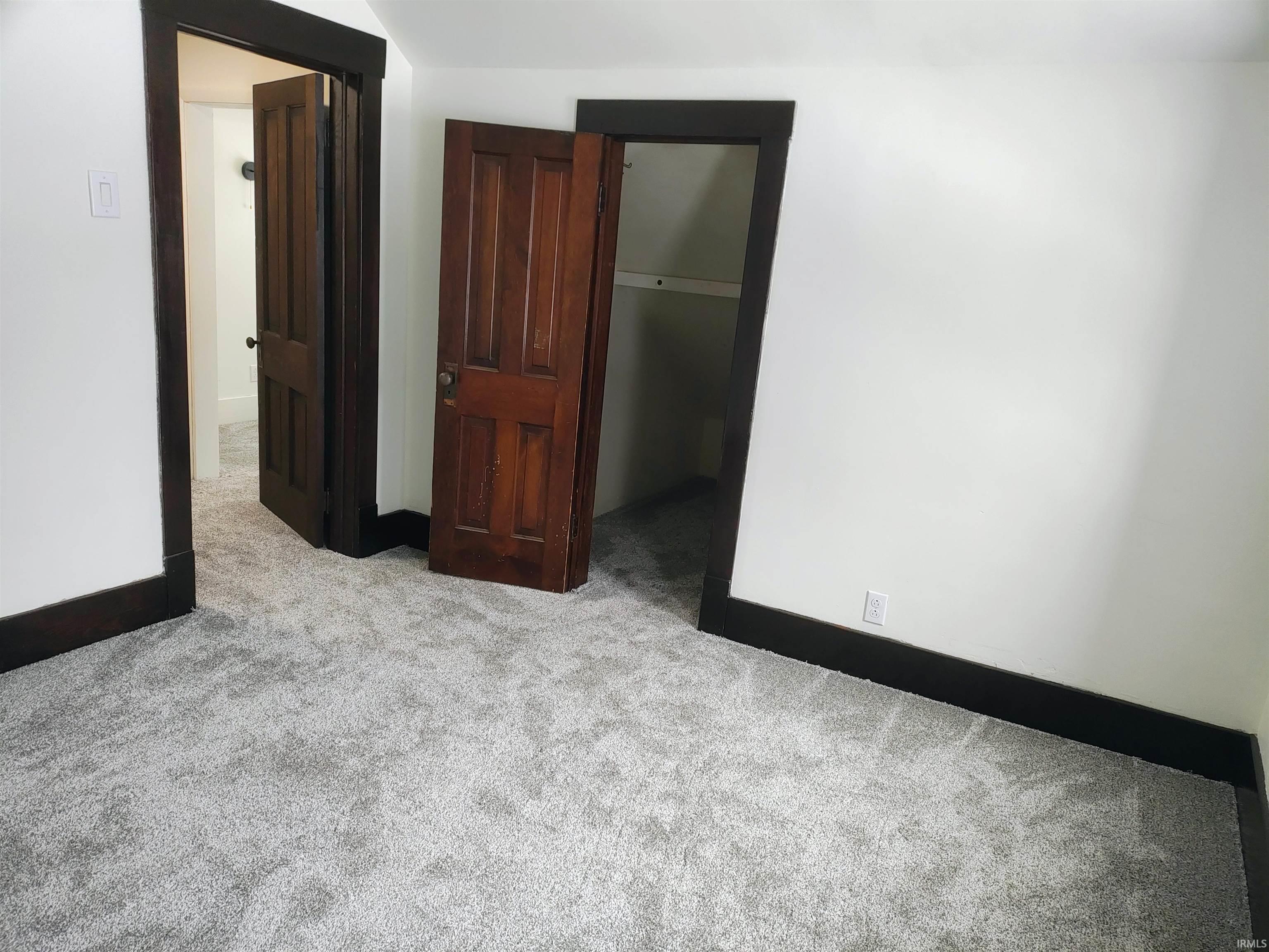 Unfurnished bedroom featuring light colored carpet and a spacious closet