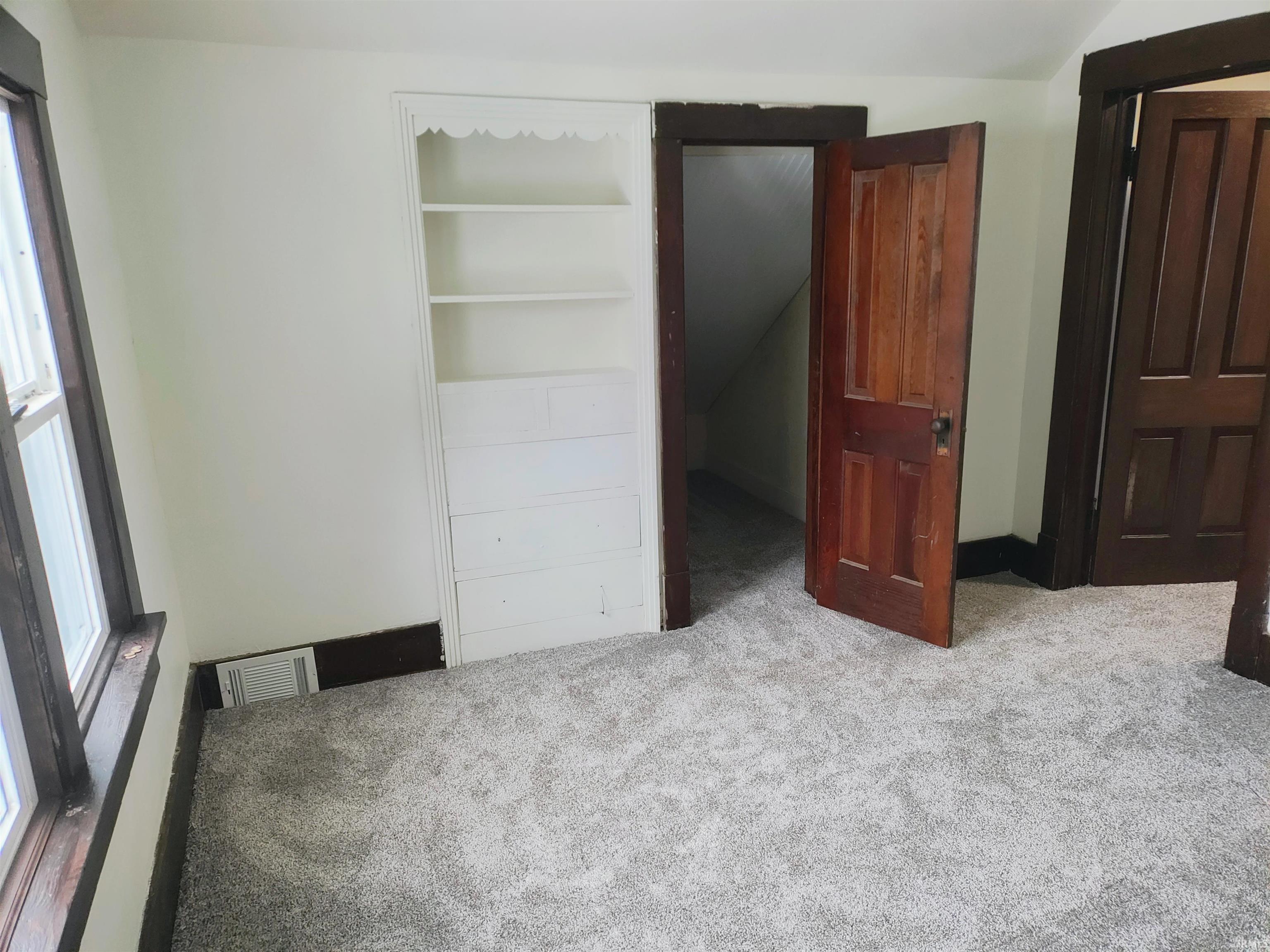 Unfurnished bedroom featuring carpet flooring