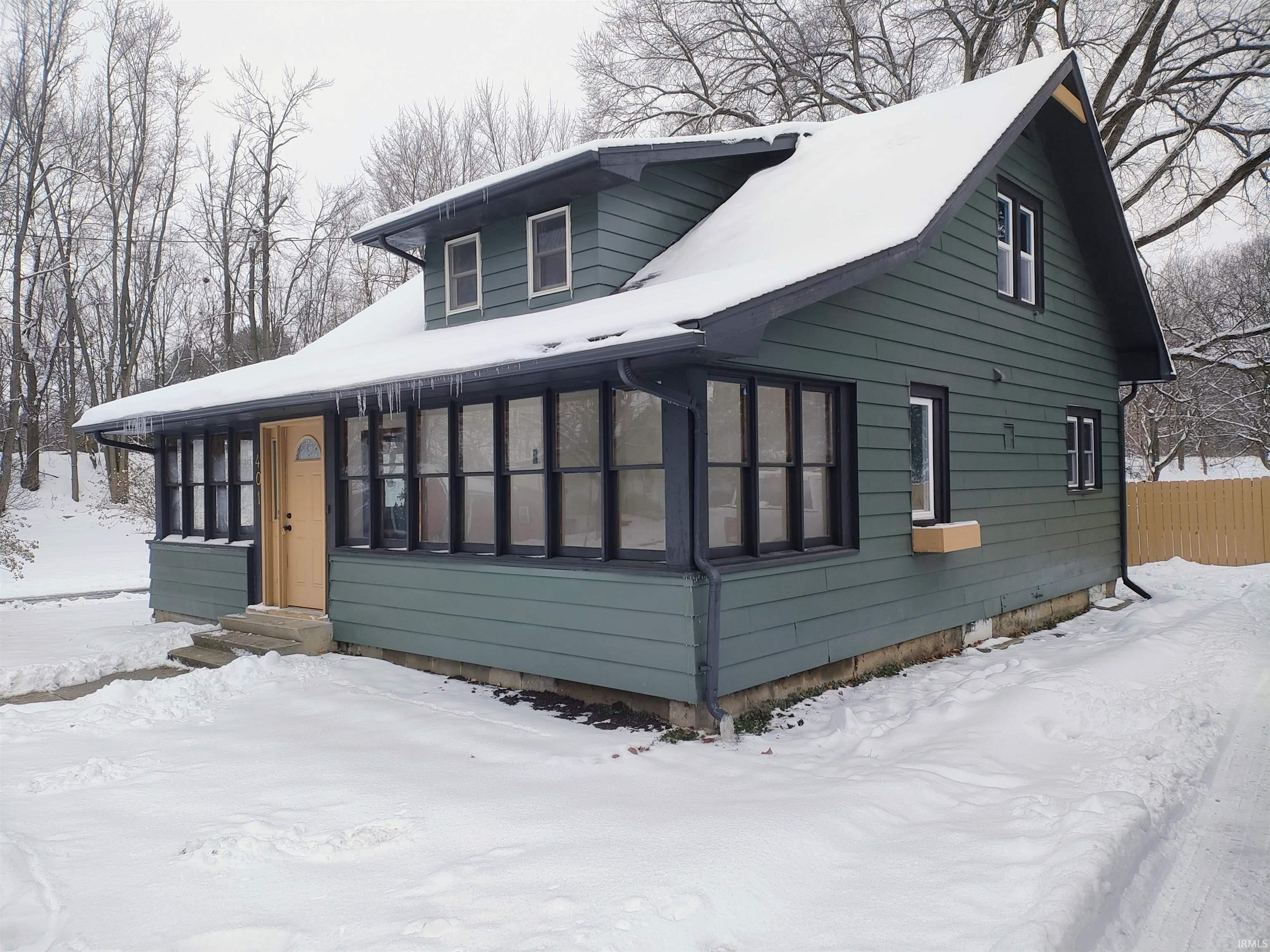 View of snow covered exterior featuring entry steps