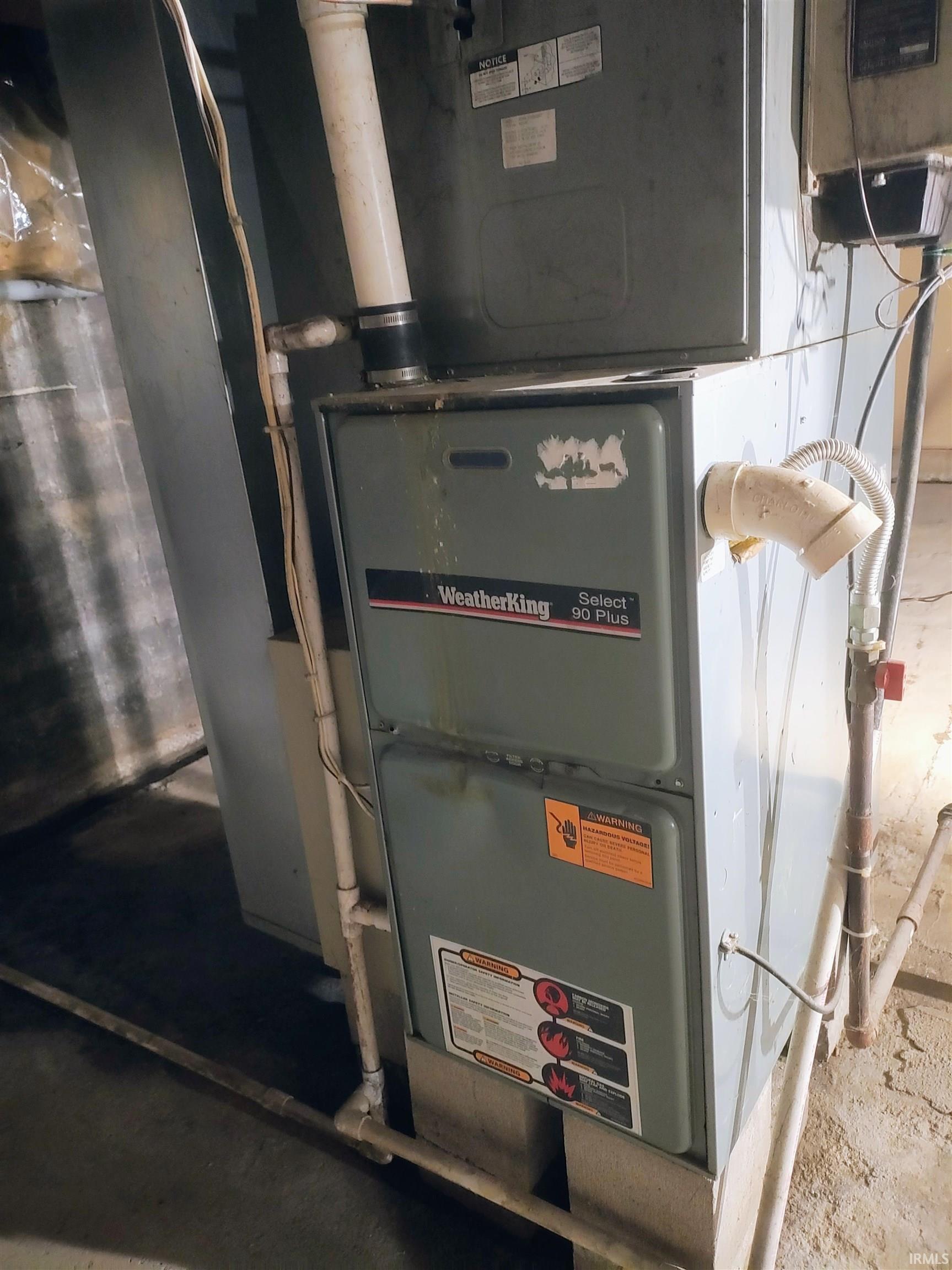 Utility room featuring heating unit