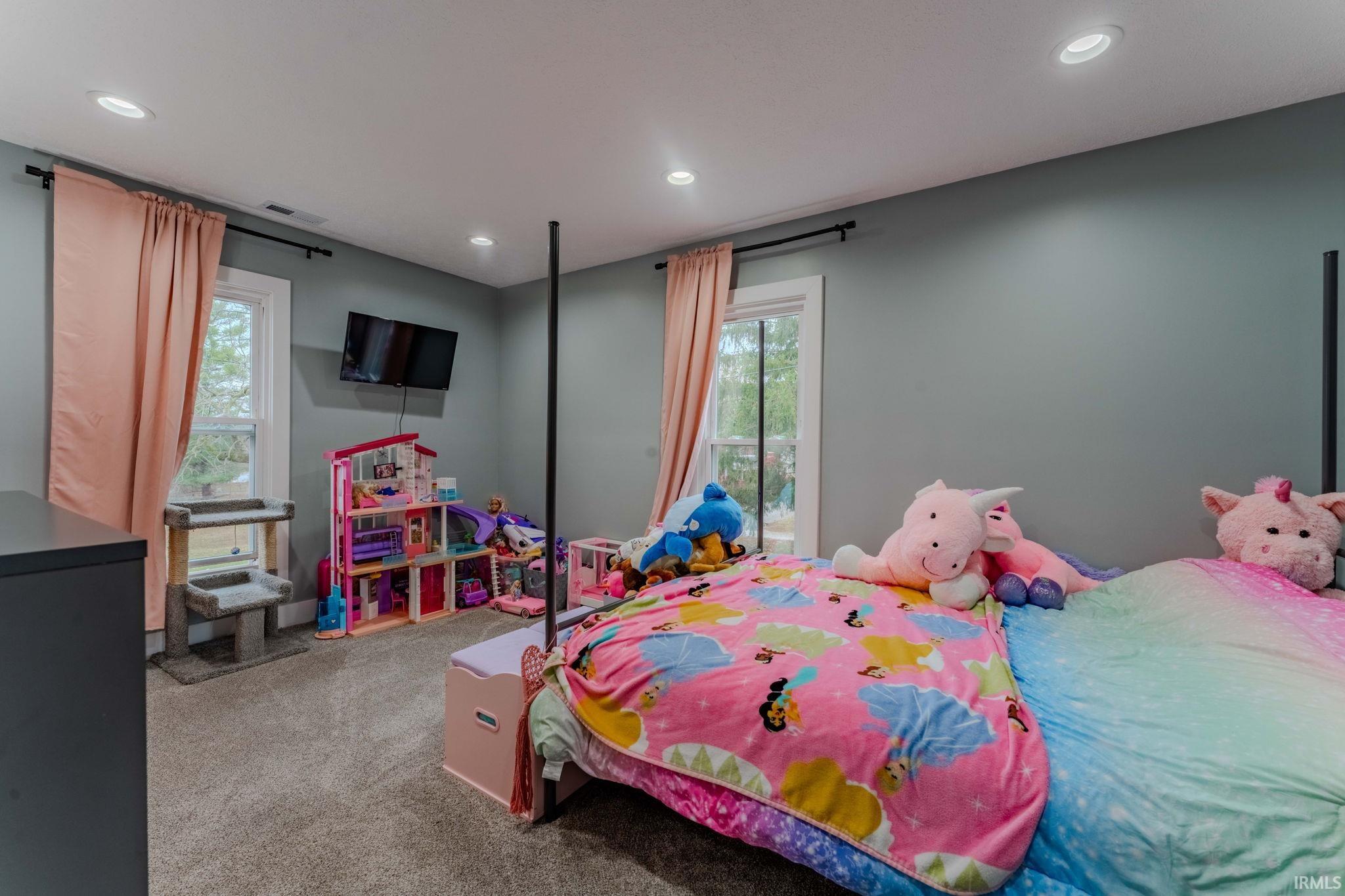 Carpeted bedroom with recessed lighting