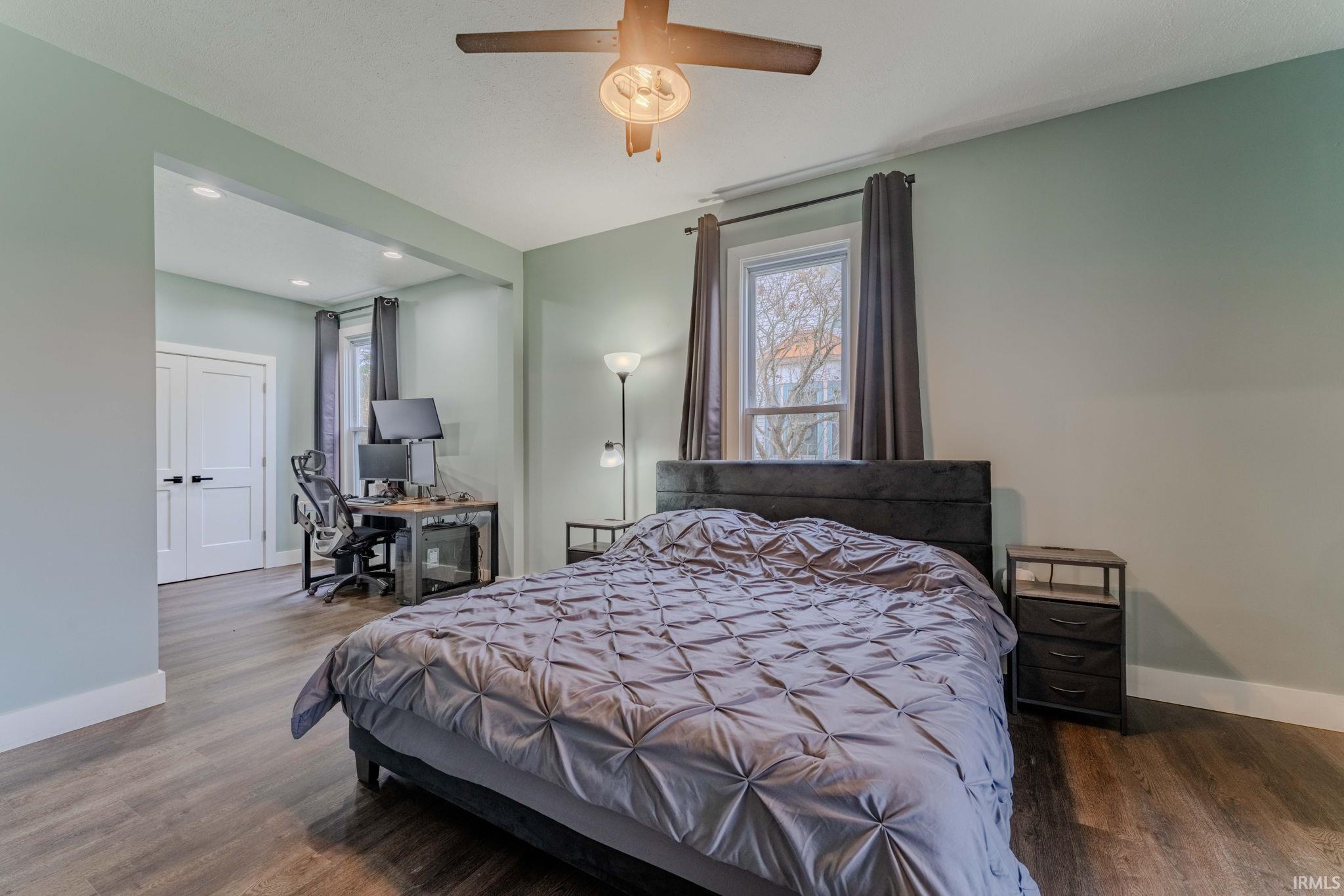 Bedroom featuring a desk, wood finished floors, ceiling fan, and recessed lighting