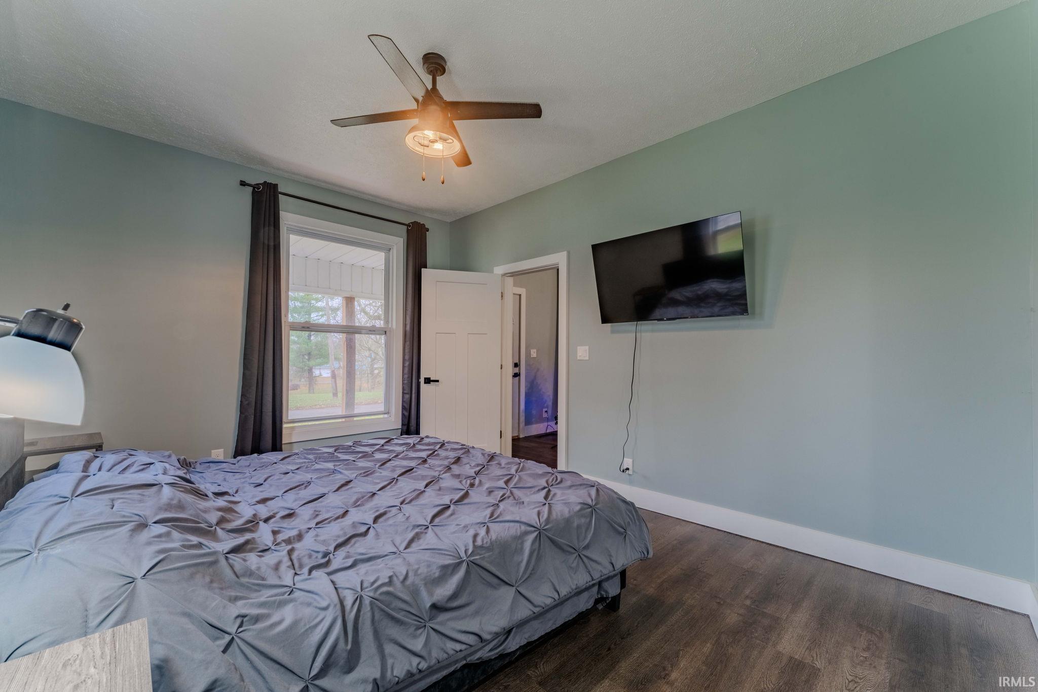 Bedroom featuring ceiling fan and wood finished floors