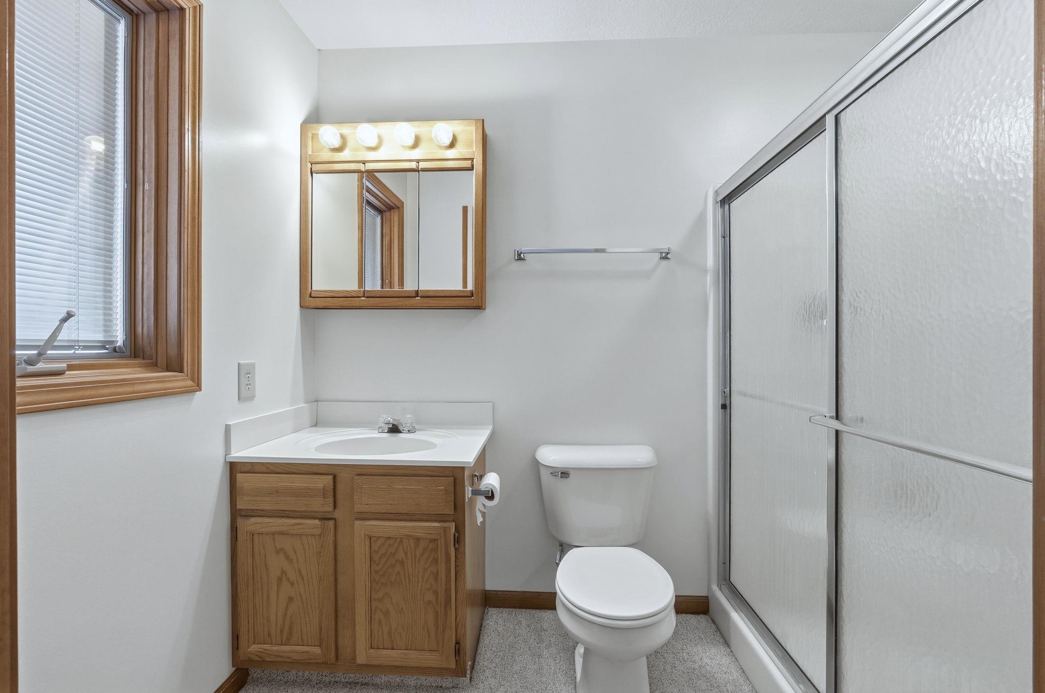 Full bath featuring vanity and a shower stall