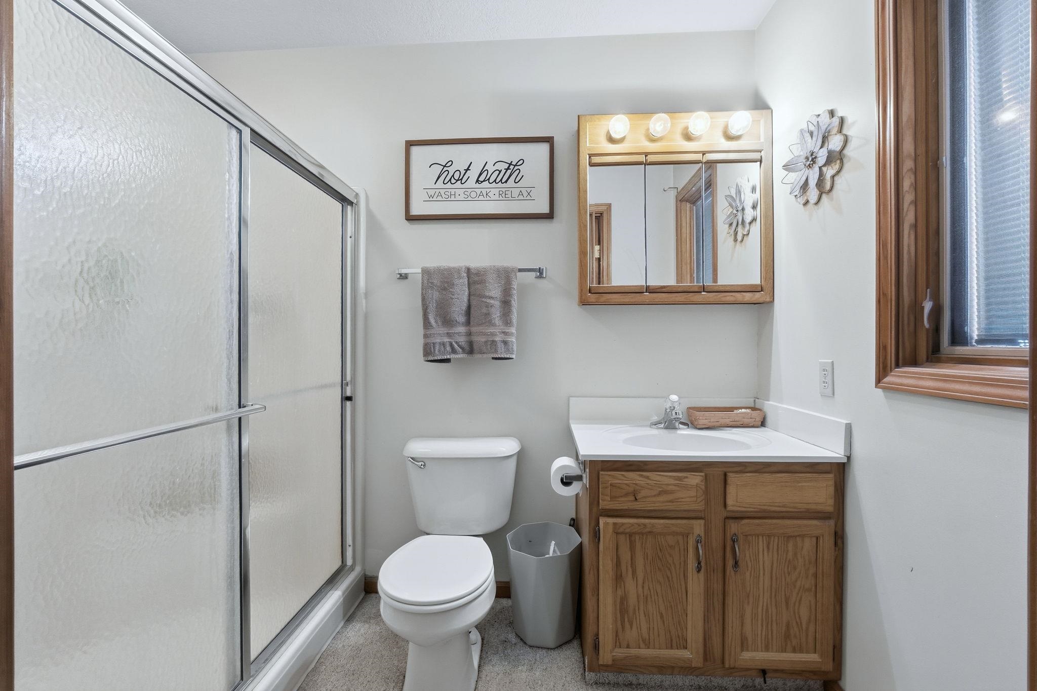 Bathroom with vanity and a shower stall